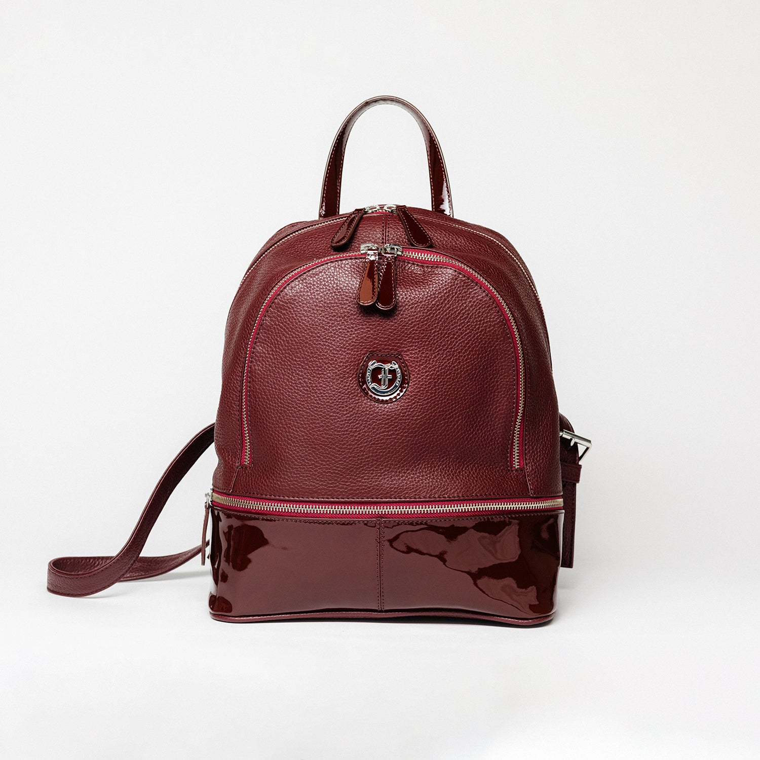 Burgundy leather Brougham Backpack on a white background.