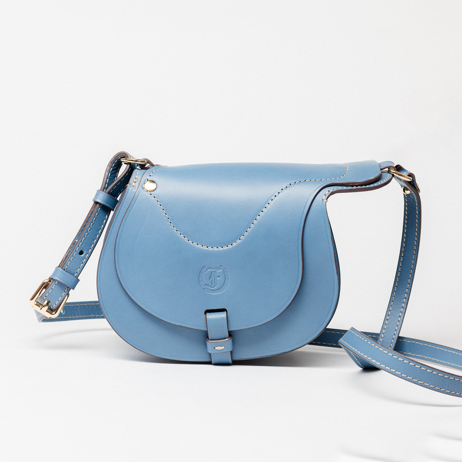 Close-up of Freedman's Blue Leather Derby Shoulder Bag: Saddle-Inspired Flap Closure and Detailed Stitching