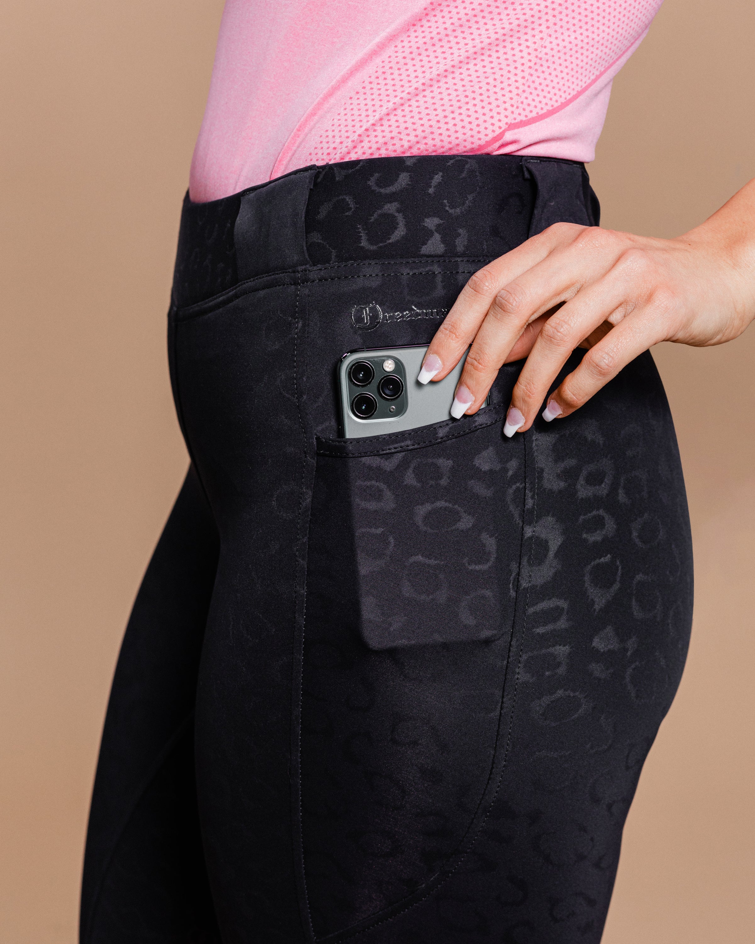 Stylish Tous les Jours Jods - Black Cheetah by Freedman's – sleek, comfortable, and perfect for equestrian fashion. Close up of pocket with Freeman's name print and phone.
