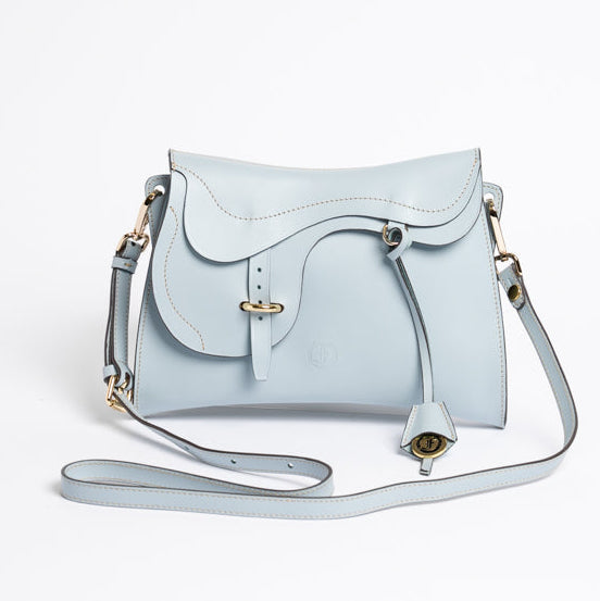 Trooper Shoulder Bag in Aquamarine leather by Freedman Harness – sculptural crossbody with saddle-inspired flap, white contrast stitching, and gold hardware