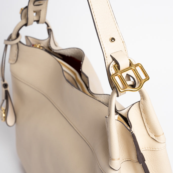 Close-up of Wetherby Tote by Freedman Harness – Putty leather shoulder bag featuring gold buckle hardware, adjustable strap, and contrast edge detailing