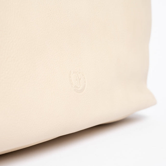 Embossed Freedman Harness logo on beige leather of Wetherby Tote – subtle branding detail on premium putty leather