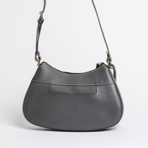 Back view of Carlisle Bag in grey leather by Freedman Harness – curved crossbody handbag with contrast stitching, back slip pocket, and adjustable strap