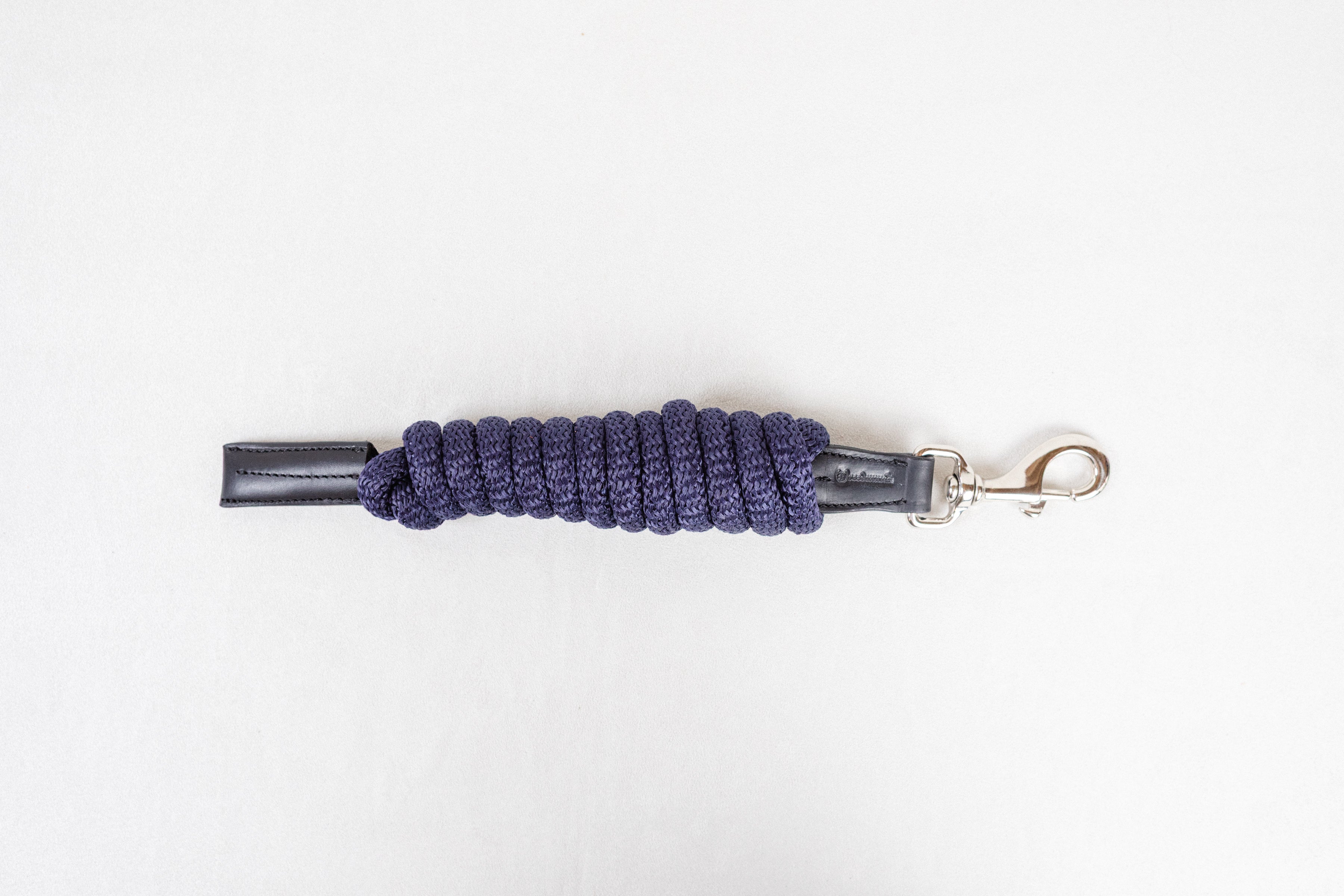 Freedman Harness navy paracord poly lead rope with premium black leather accents and a stainless steel snap on a white background.