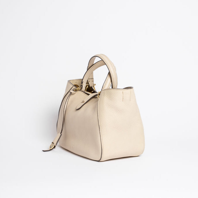 Side view of Midi Cabriolet Bag by Freedman Harness – beige leather handbag with structured silhouette, top handles, and gold hardware