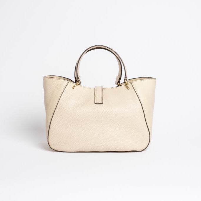 Back view of Midi Cabriolet Bag by Freedman Harness – beige leather handbag with curved structure, gold-tone hardware, and double handles