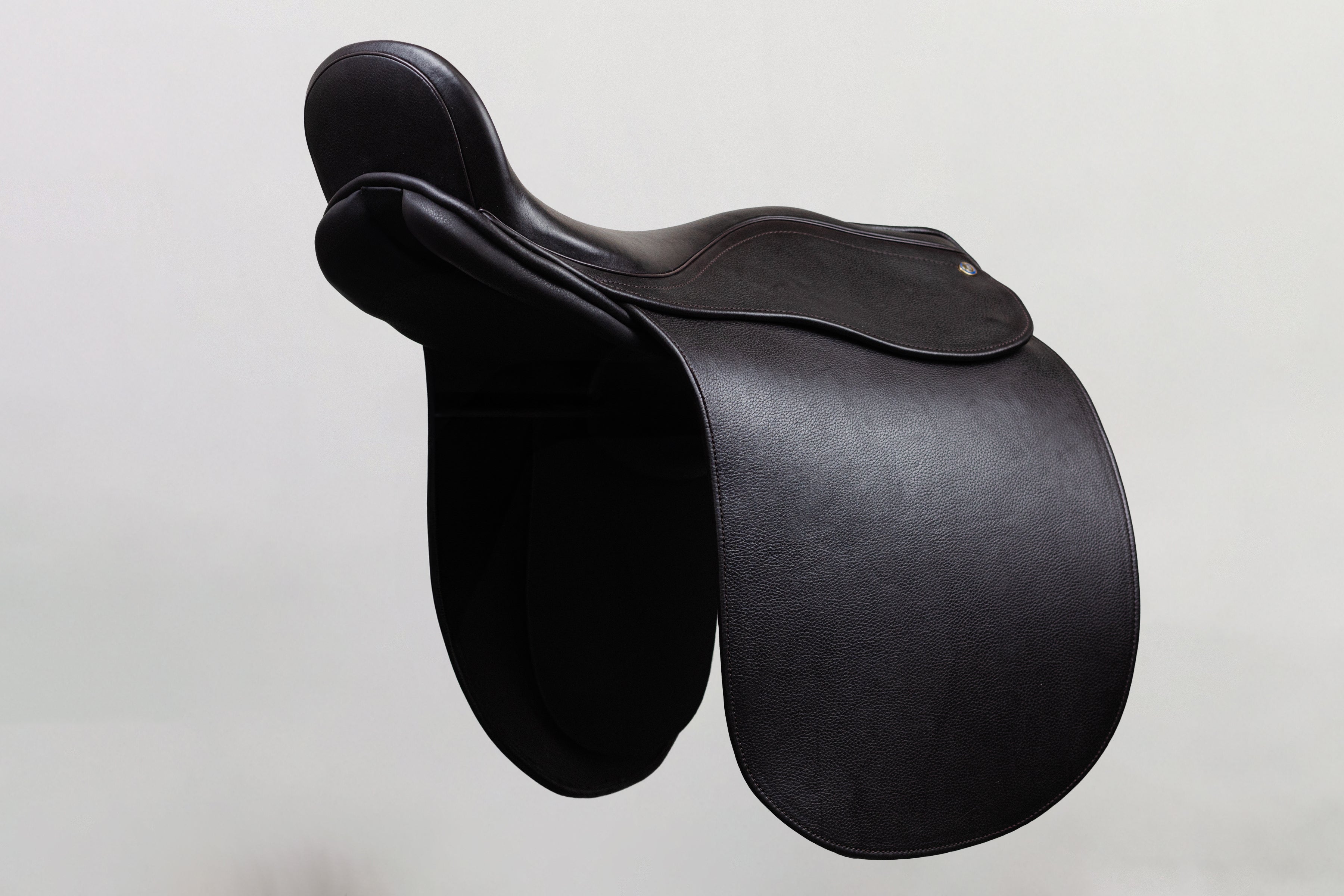 Ultra XD Saddle cutback saddle with a deep seat design for a secure riding experience, shown in angled side profile in dark leather.