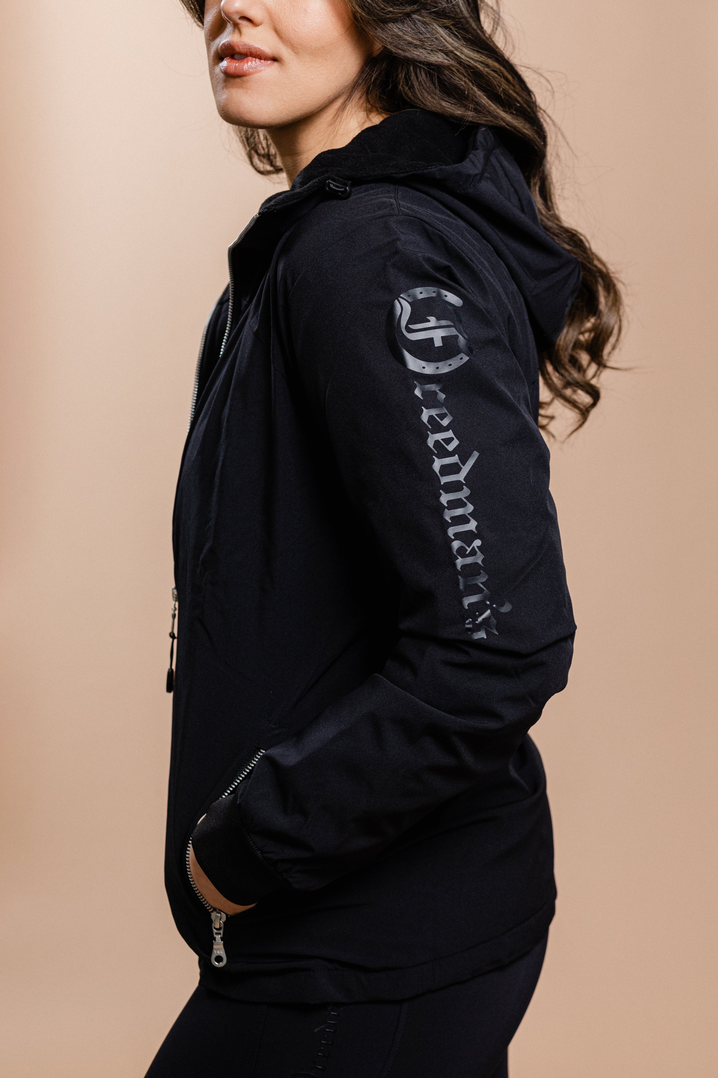 Ladies Team Freedman's Jacket, black with silver "Freedman" text on sleeve, side view.
