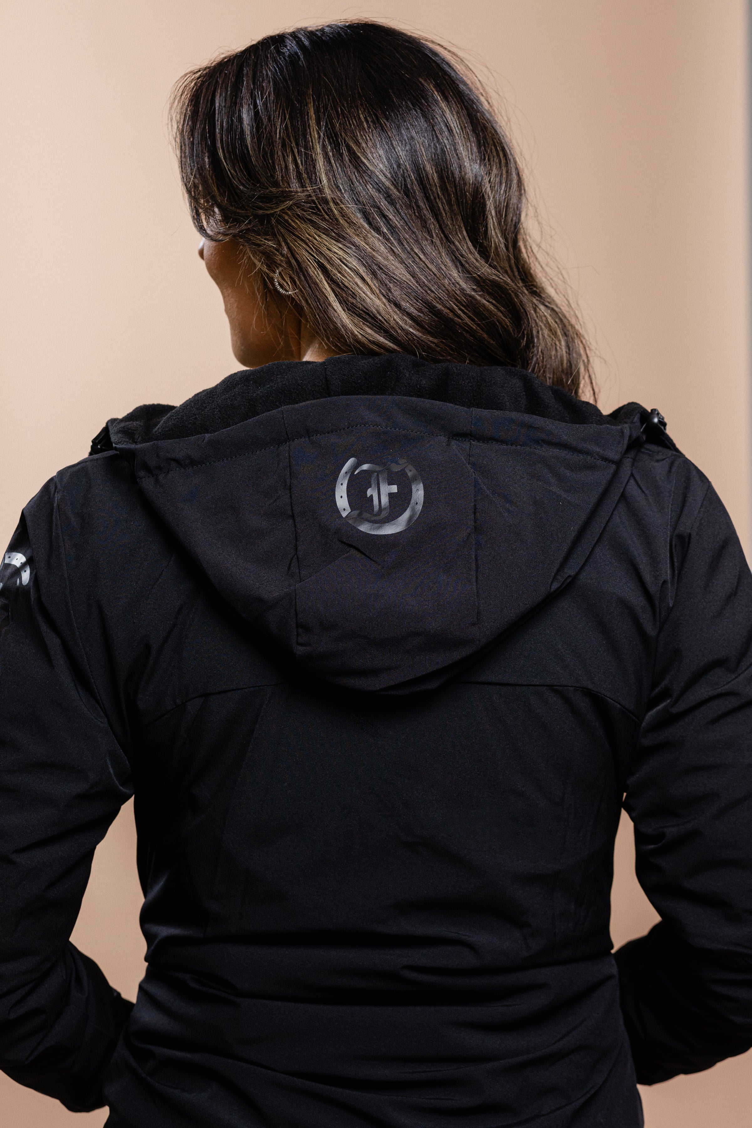 Black Ladies Team Freedman's Jacket, rear view with focus on the logo detail on the hood
