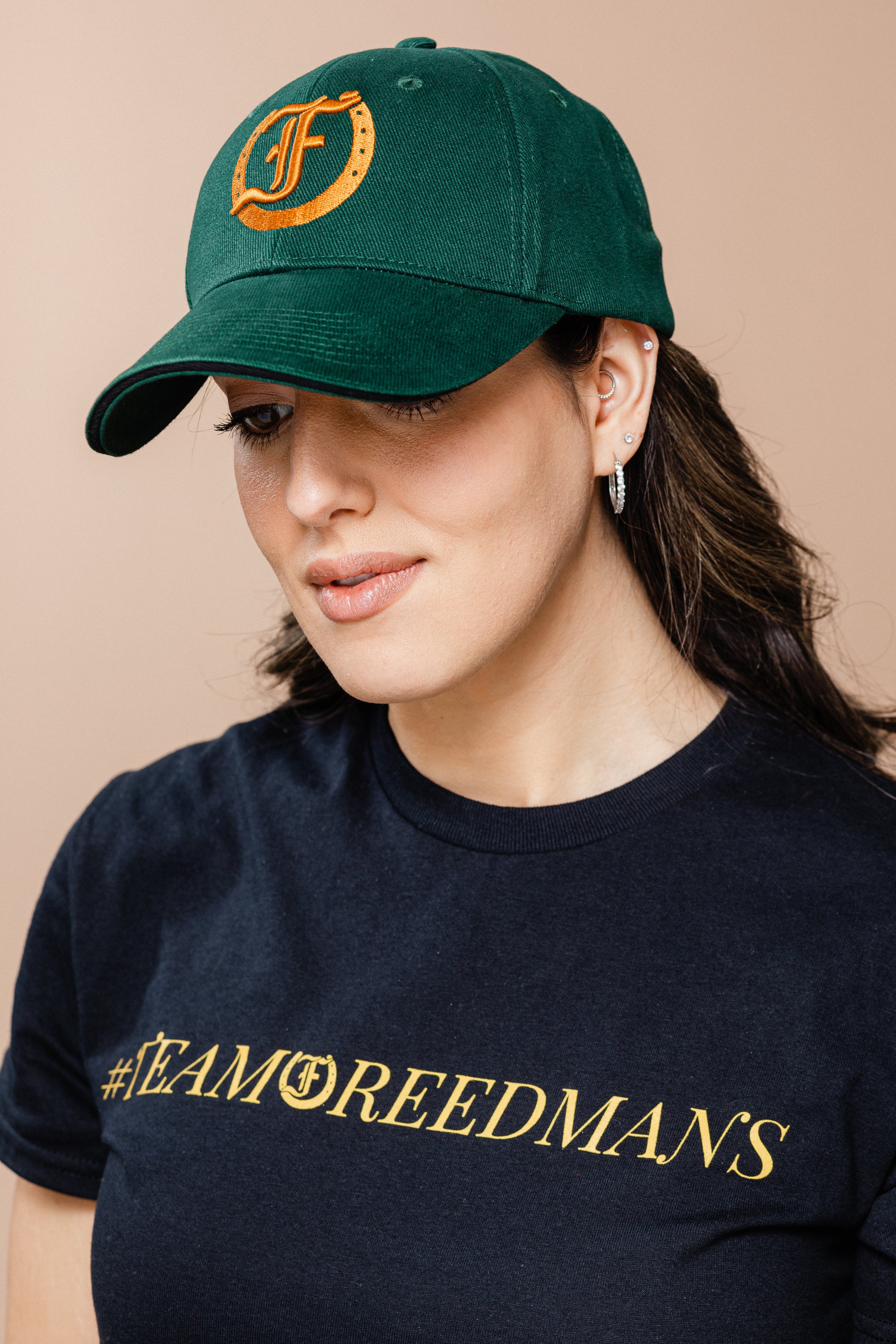 Women wearing the green Freedman's Signature Ball Cap.