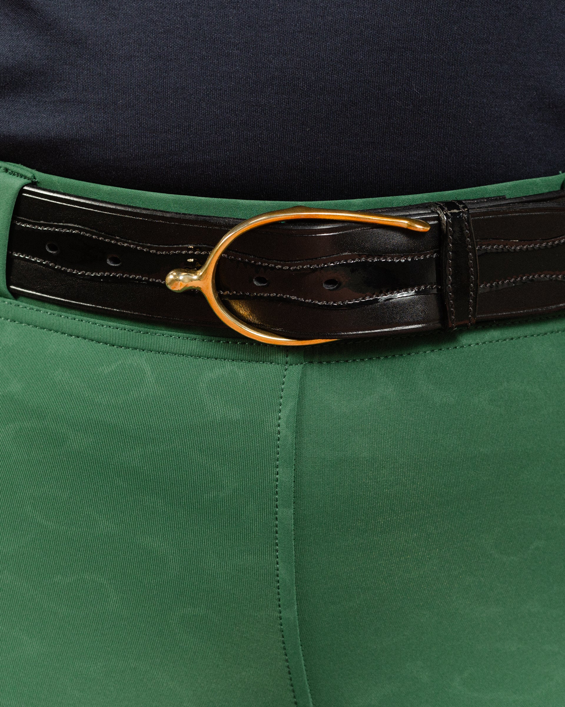Green Cheetah Jods with the Patent Scalloped Spur Belt featuring a brass buckle on a white background, made by Freedman’s Harness.