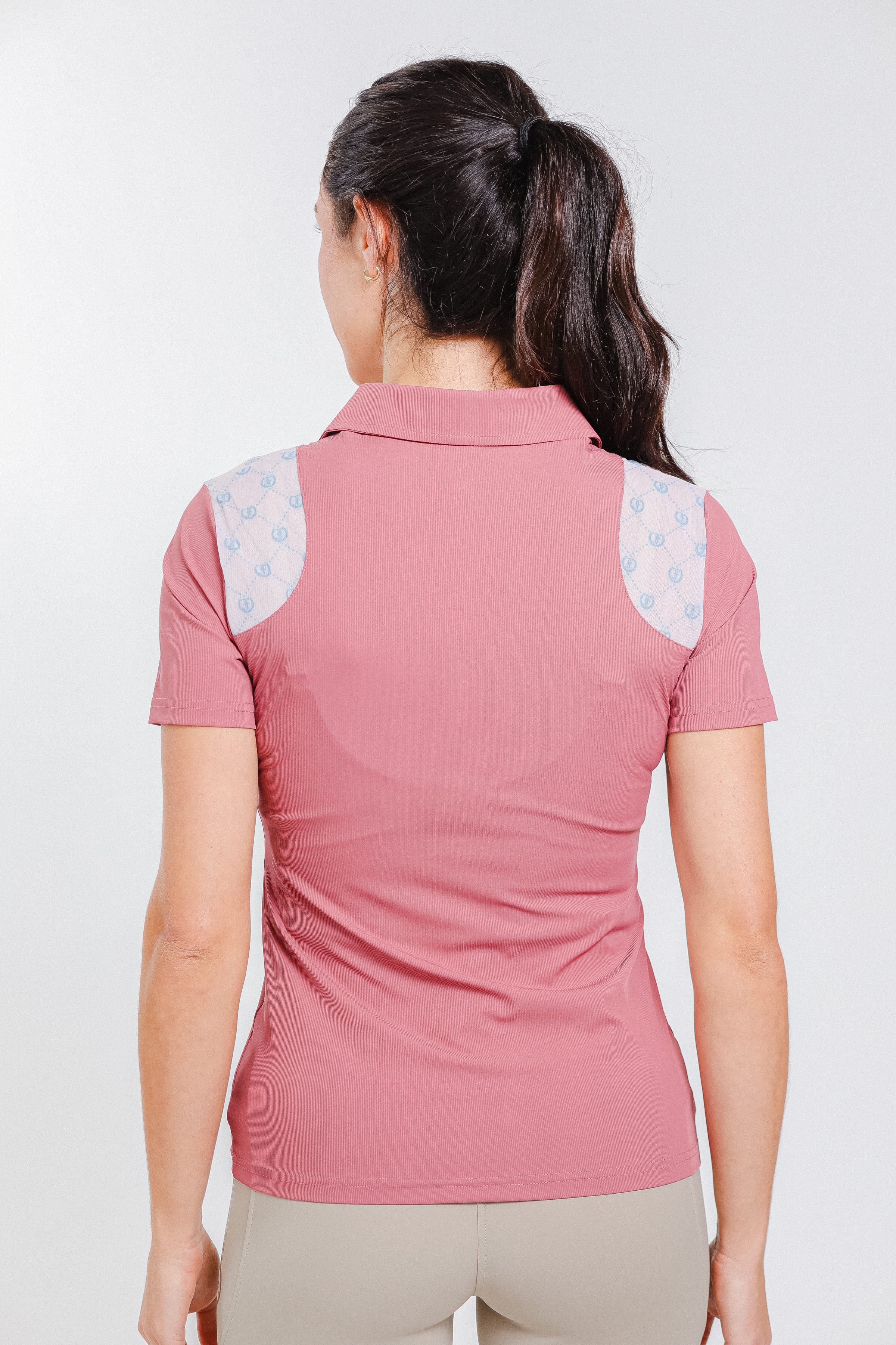 Pink Ladies' 1/4 Zip Polo by Freedman's, back view showing patterned mesh shoulder panels and short sleeves.