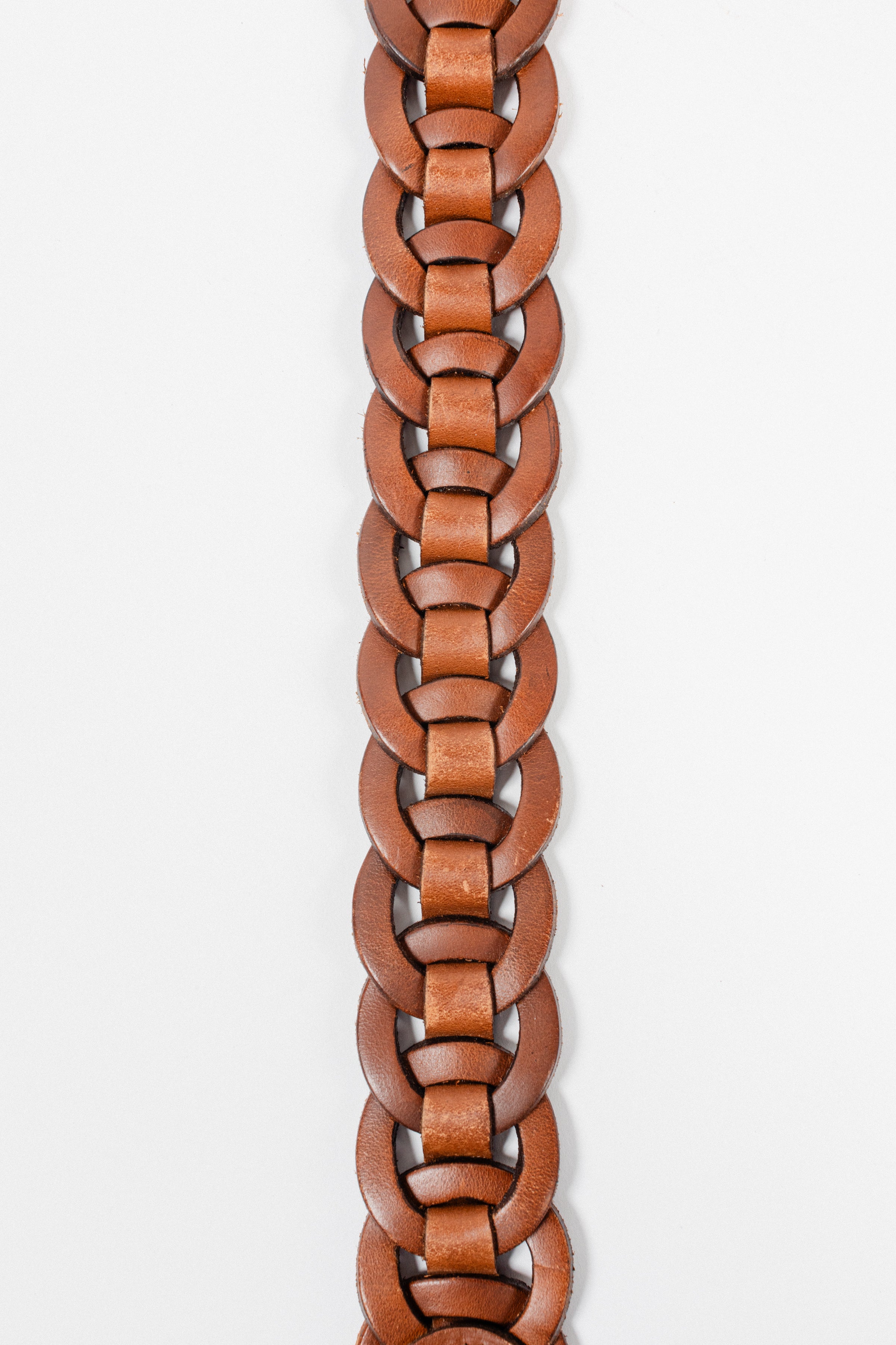 Close-up of brown leather Small Leather Ring Belt by Freedman's showing detailed woven leather rings, on a white background.