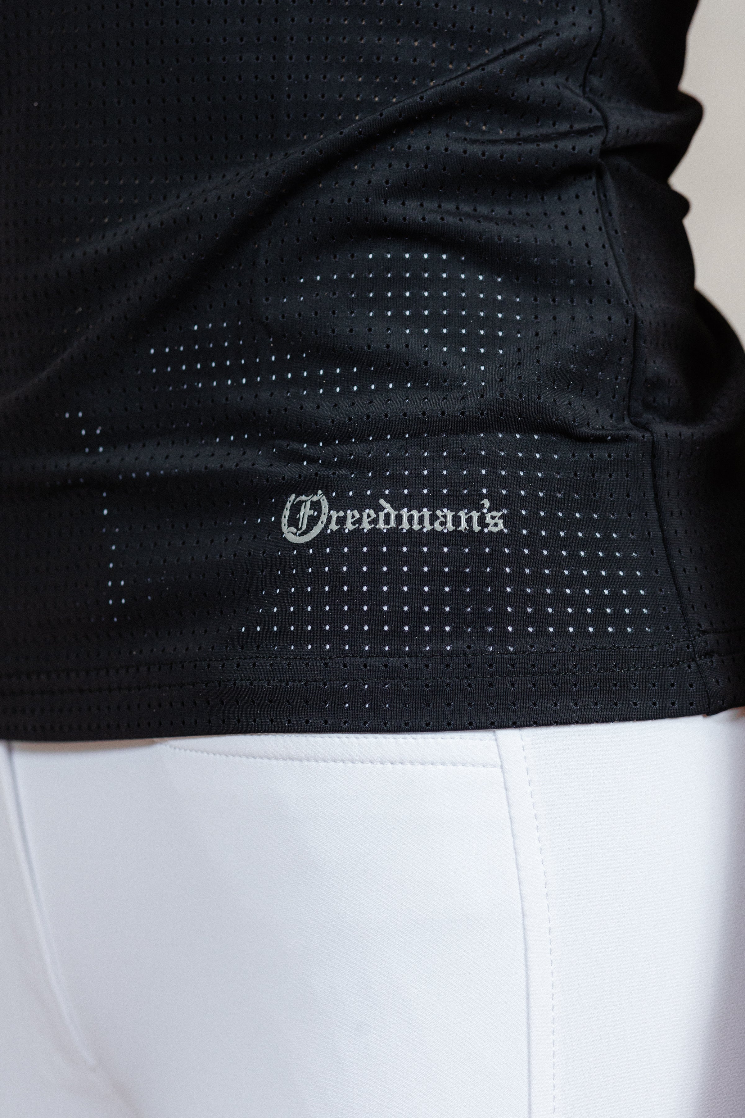 Black Laser Top with 'Freedman's' logo close up detail