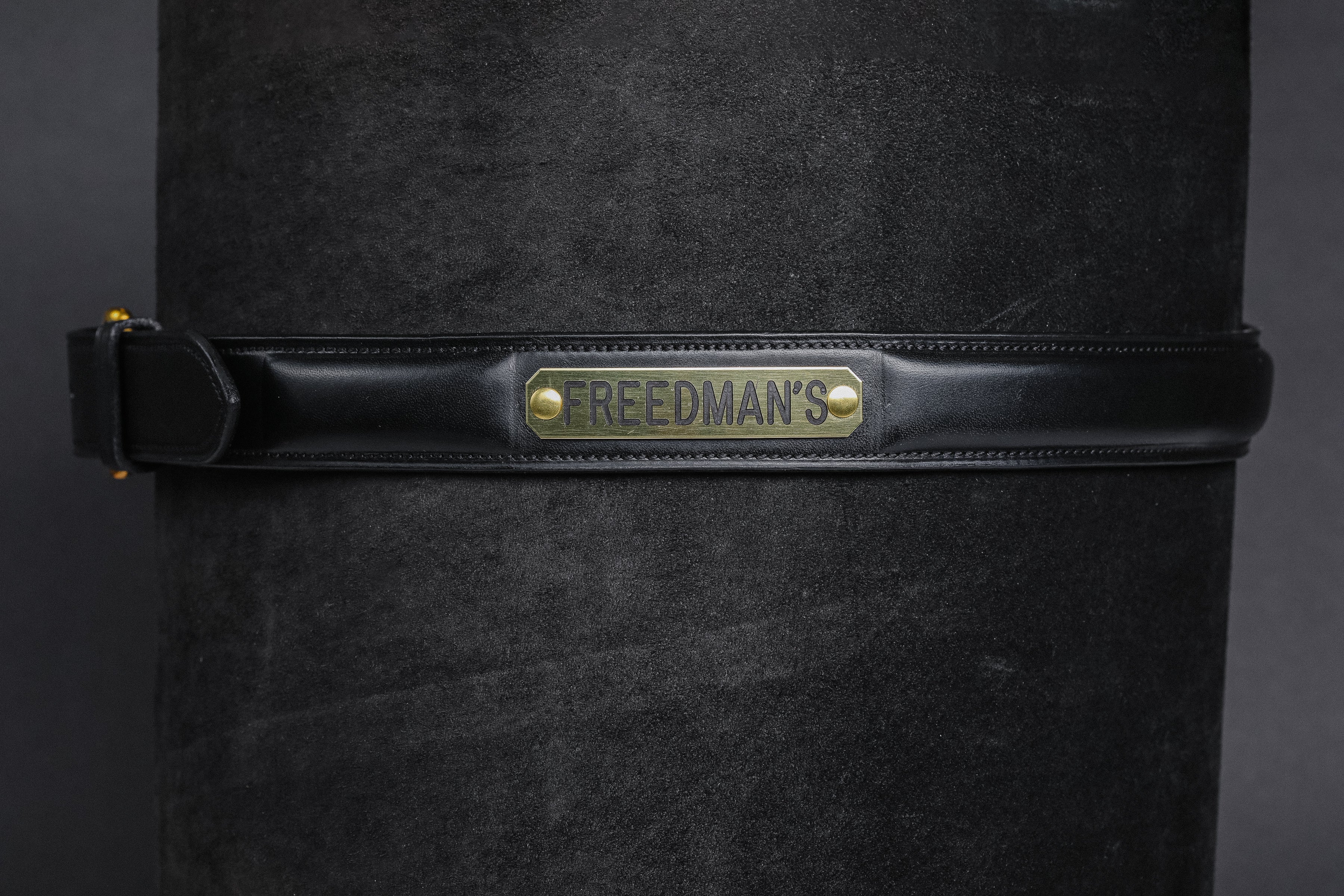 Raised Custom Name Plate Belt in dark black leather with brass buckle and "FREEDMAN'S" engraved nameplate