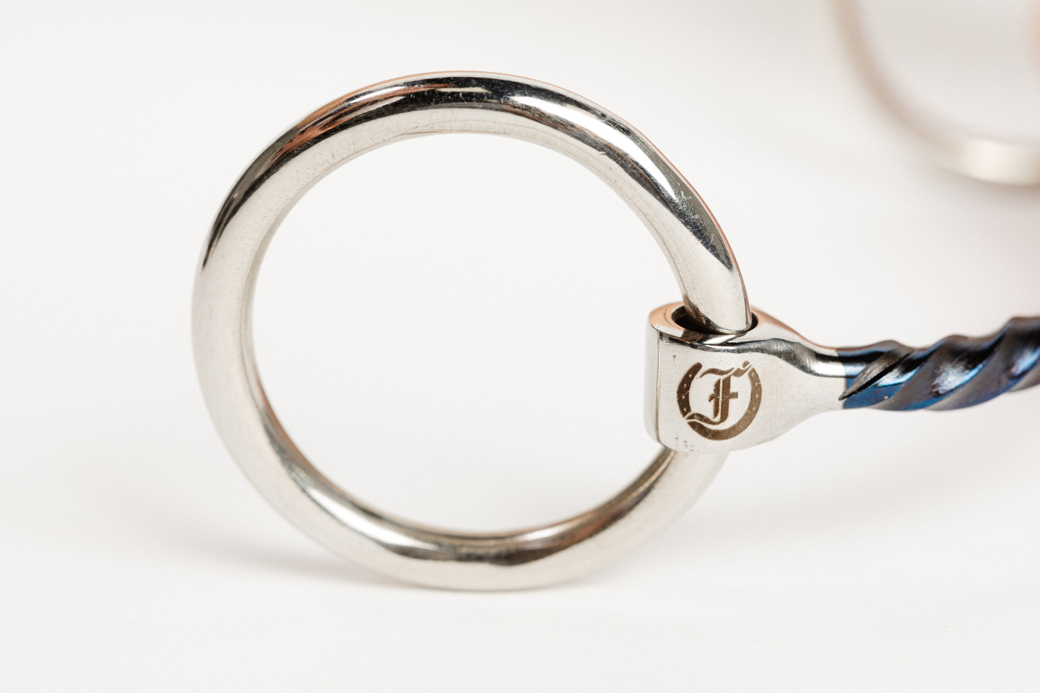 Close-up of the Loose Ring and Freedman's Logo on a Horse Bit