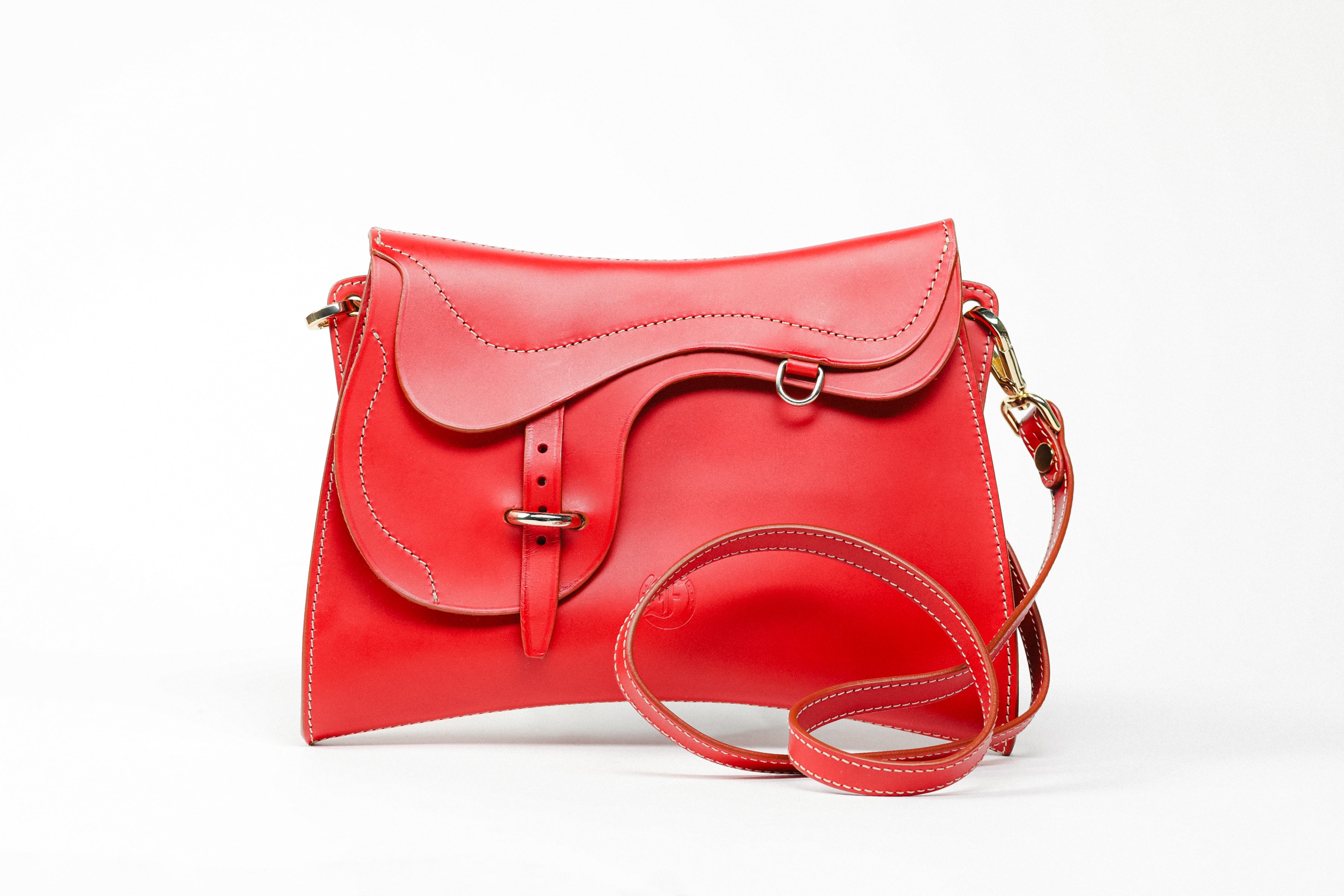 Trooper Shoulder Bag in red leather by Freedman Harness – sculptural crossbody with saddle-inspired flap, white contrast stitching, and gold hardware"
