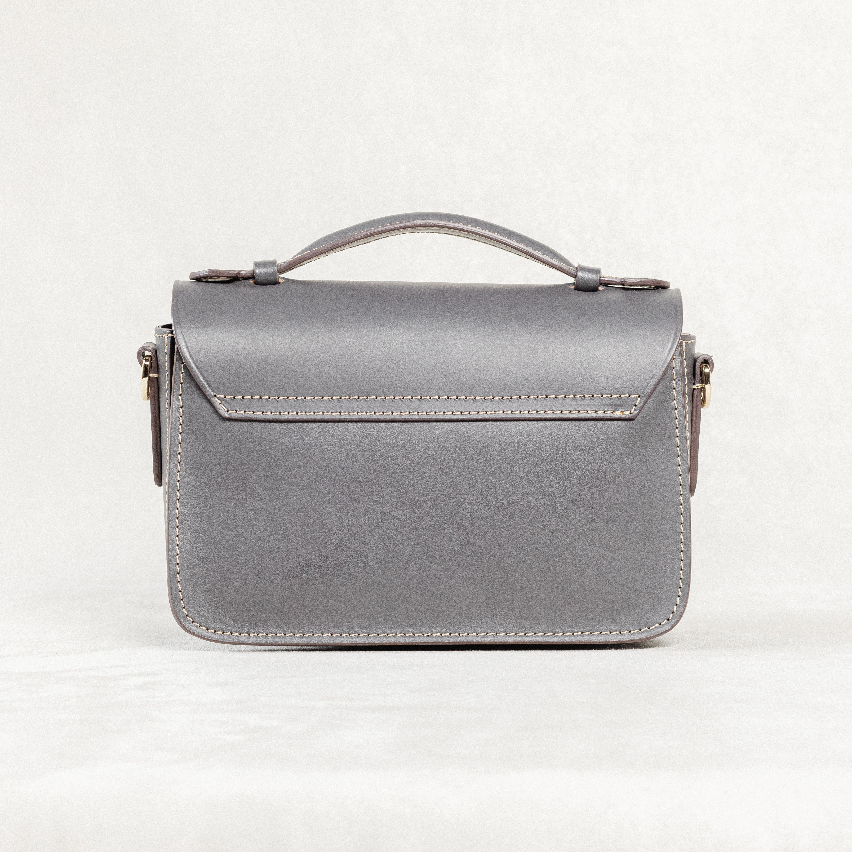 Back view of grey leather Mantelet Bag by Freedman's with top handle and stitching details.