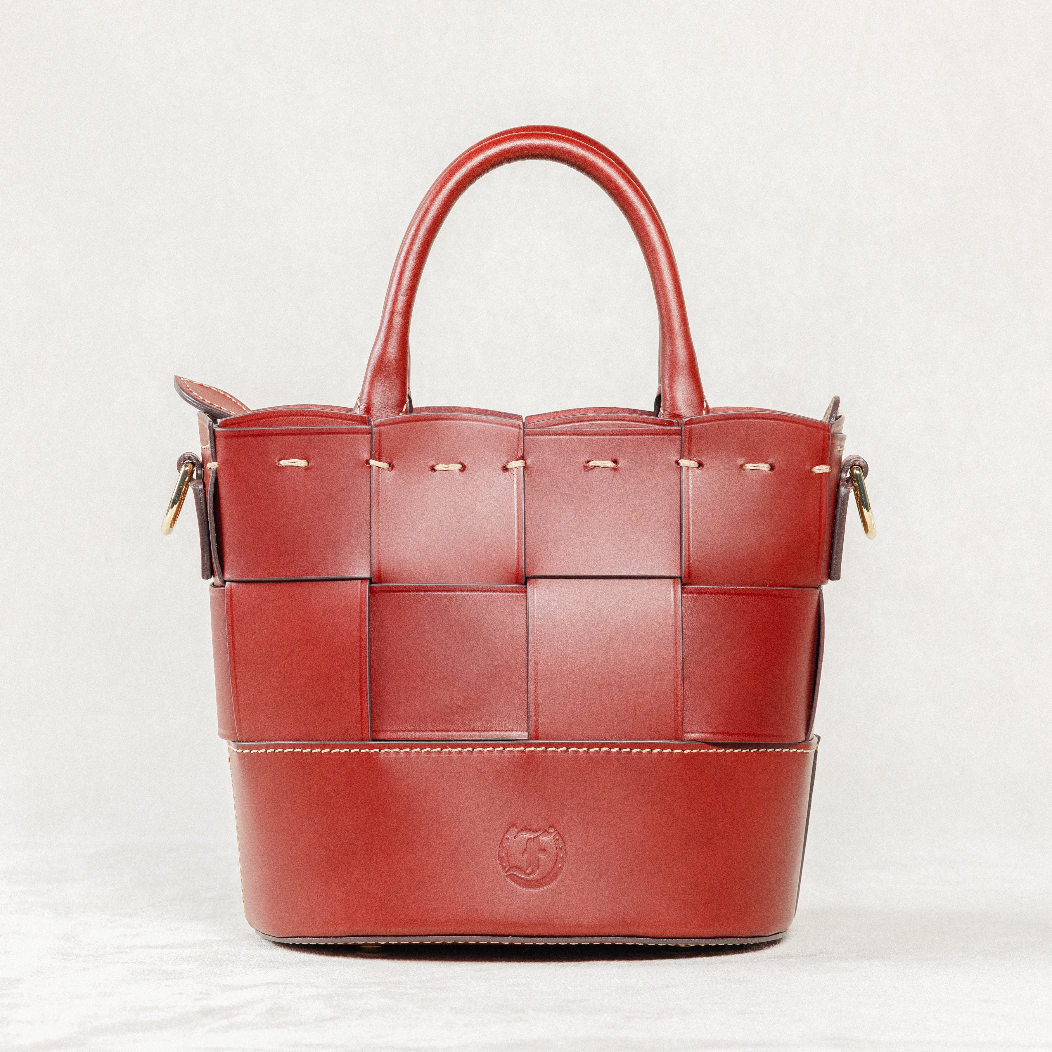Milord Bag, Brunello leather with a distinctive woven front panel, structured handles, and visible brand logo.
