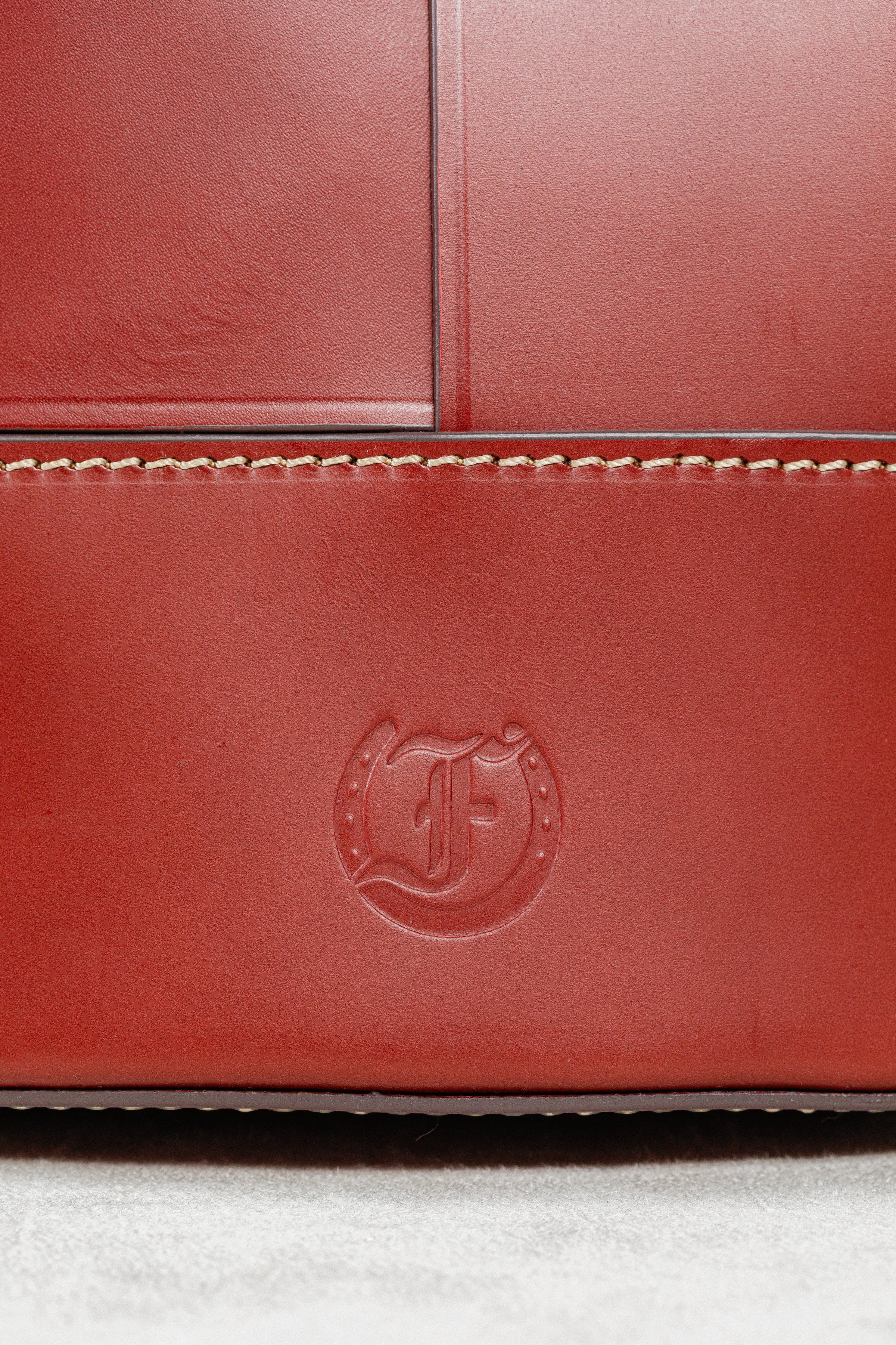 Close-up of Brunello leather Milord Bag by Freedman's, highlighting embossed brand logo and contrasting stitching details.