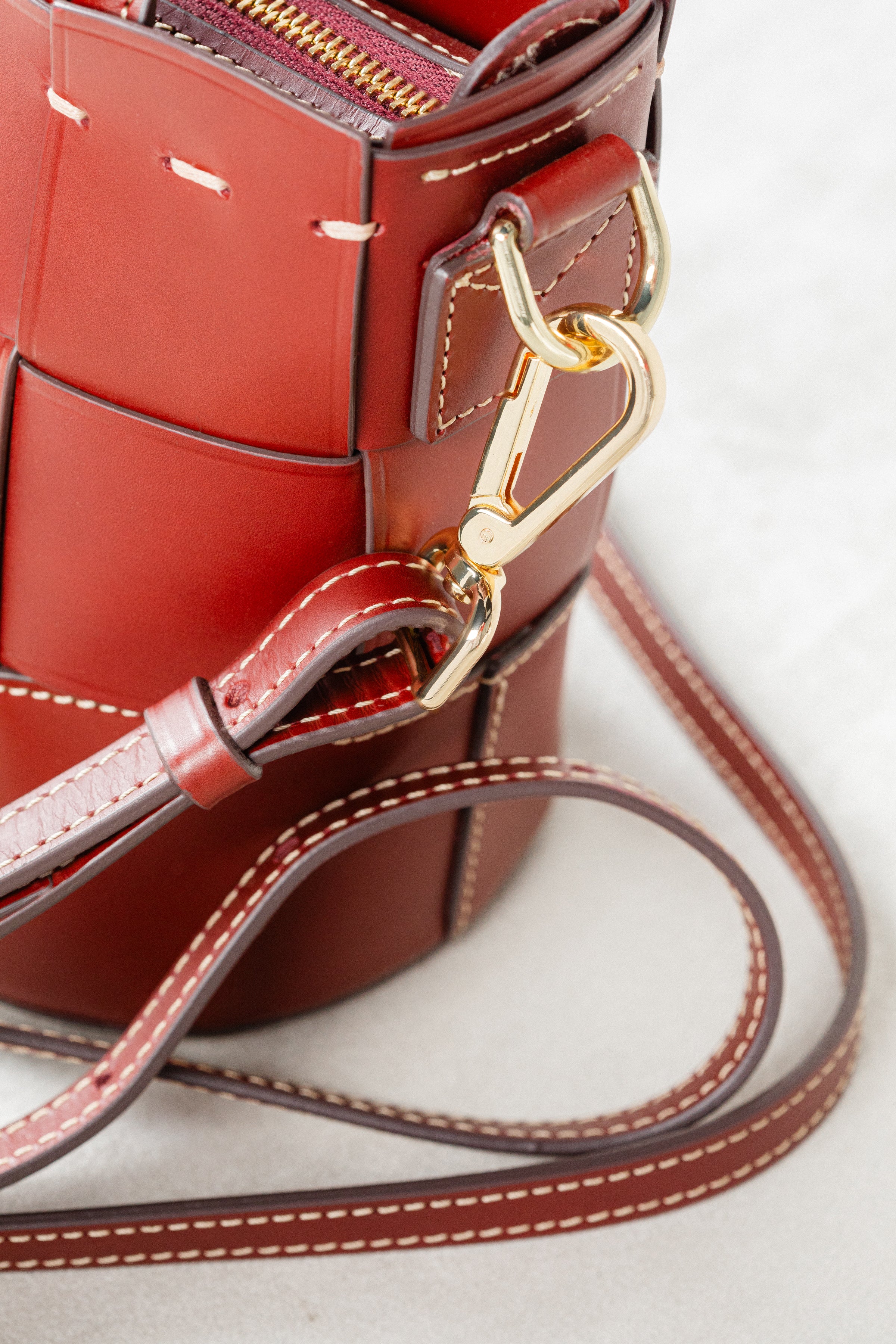 Close-up of Brunello leather Milord Bag by Freedman's, highlighting gold-tone clasp hardware and adjustable strap attachment.
