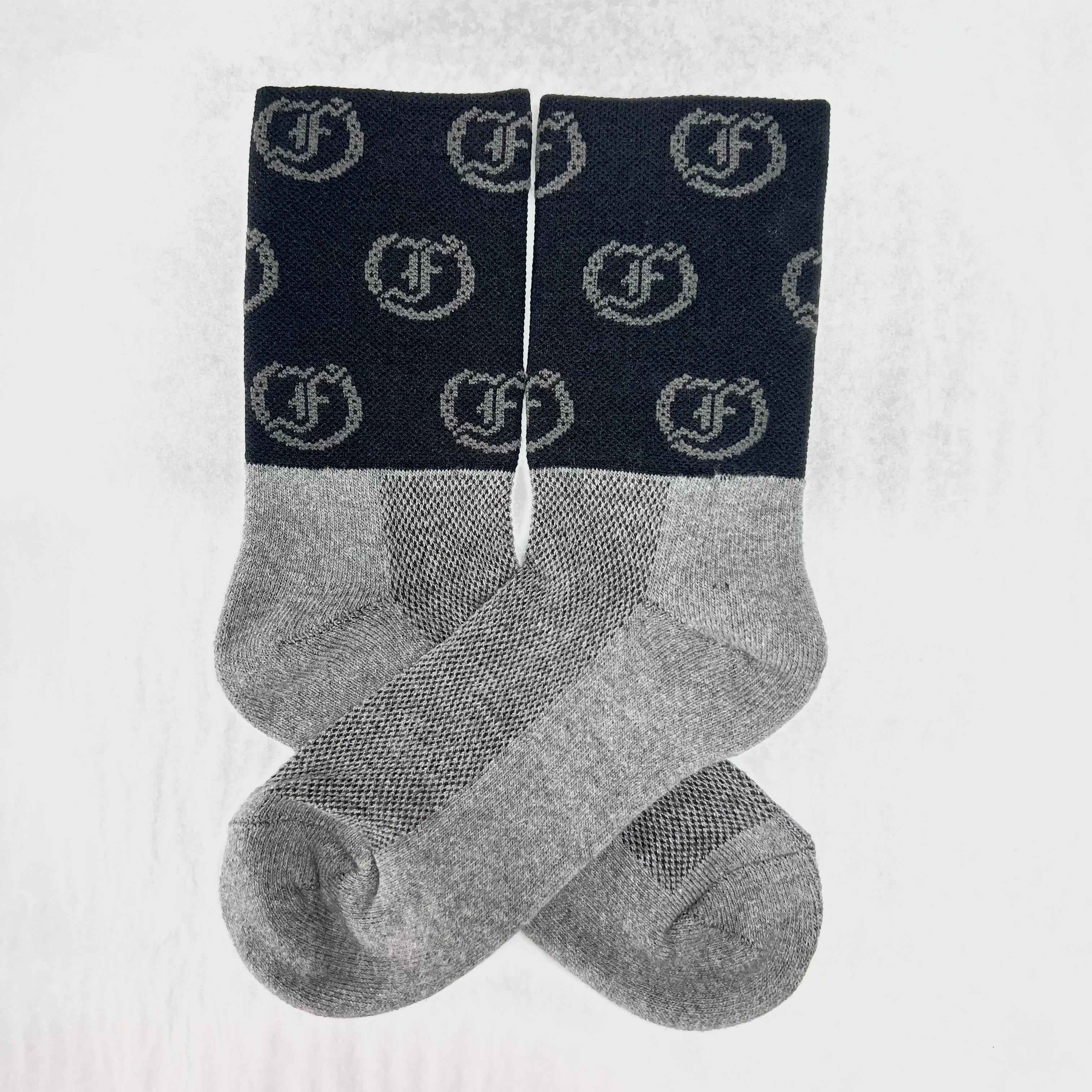 Two-tone gray and black socks with repeating Freedman's logo, laid flat with visible details and pattern