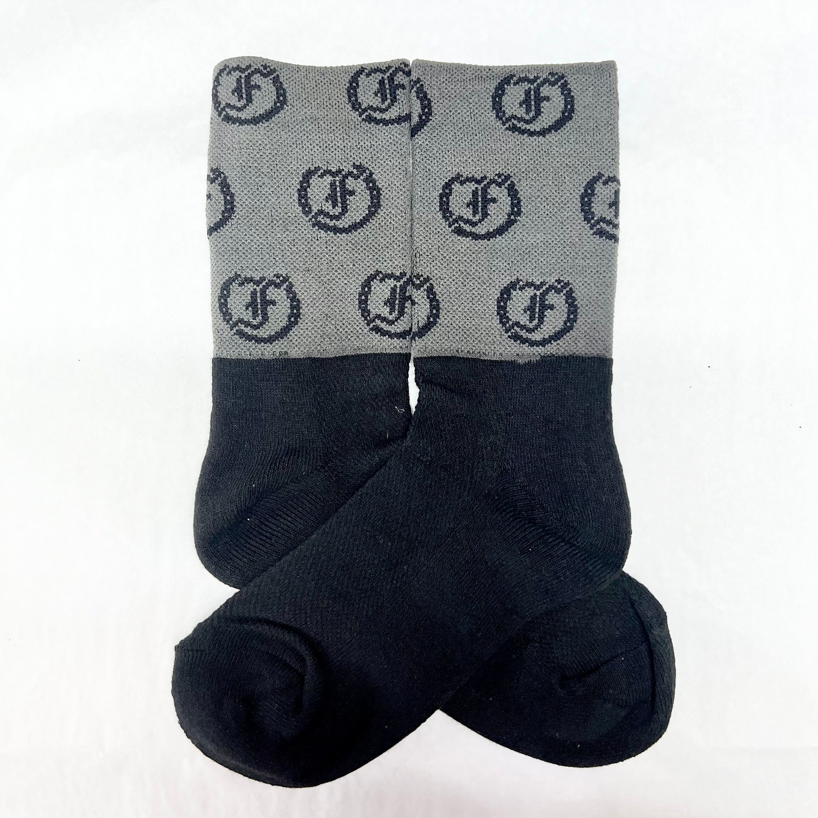 two-tone gray and black socks with repeating Freedman's logo, laid flat with visible details and pattern.
