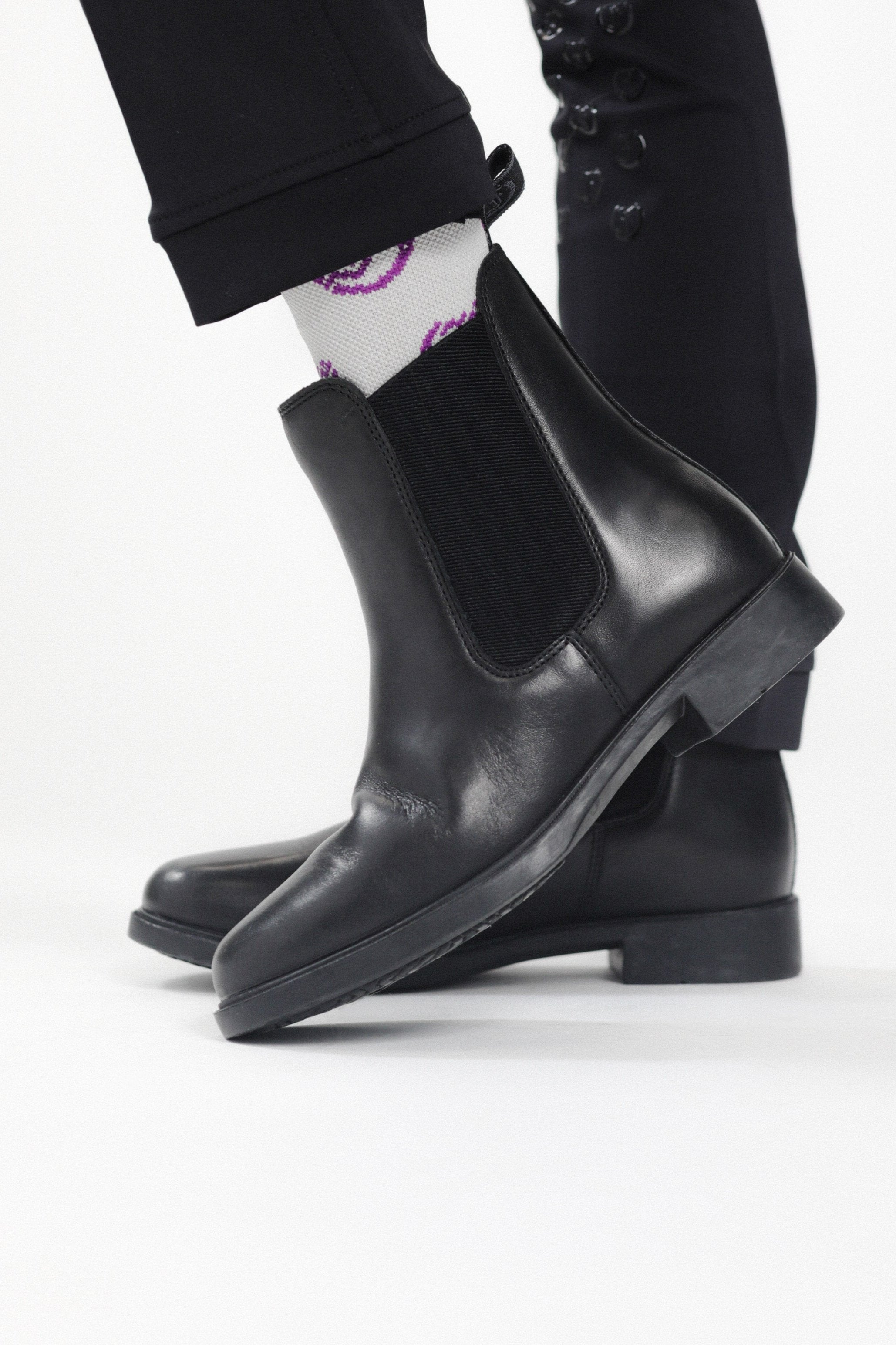 Close-up of Kids' Jodhpur Boot: Showing Black Leather Texture, Elastic Side Panel, and Low Heel
