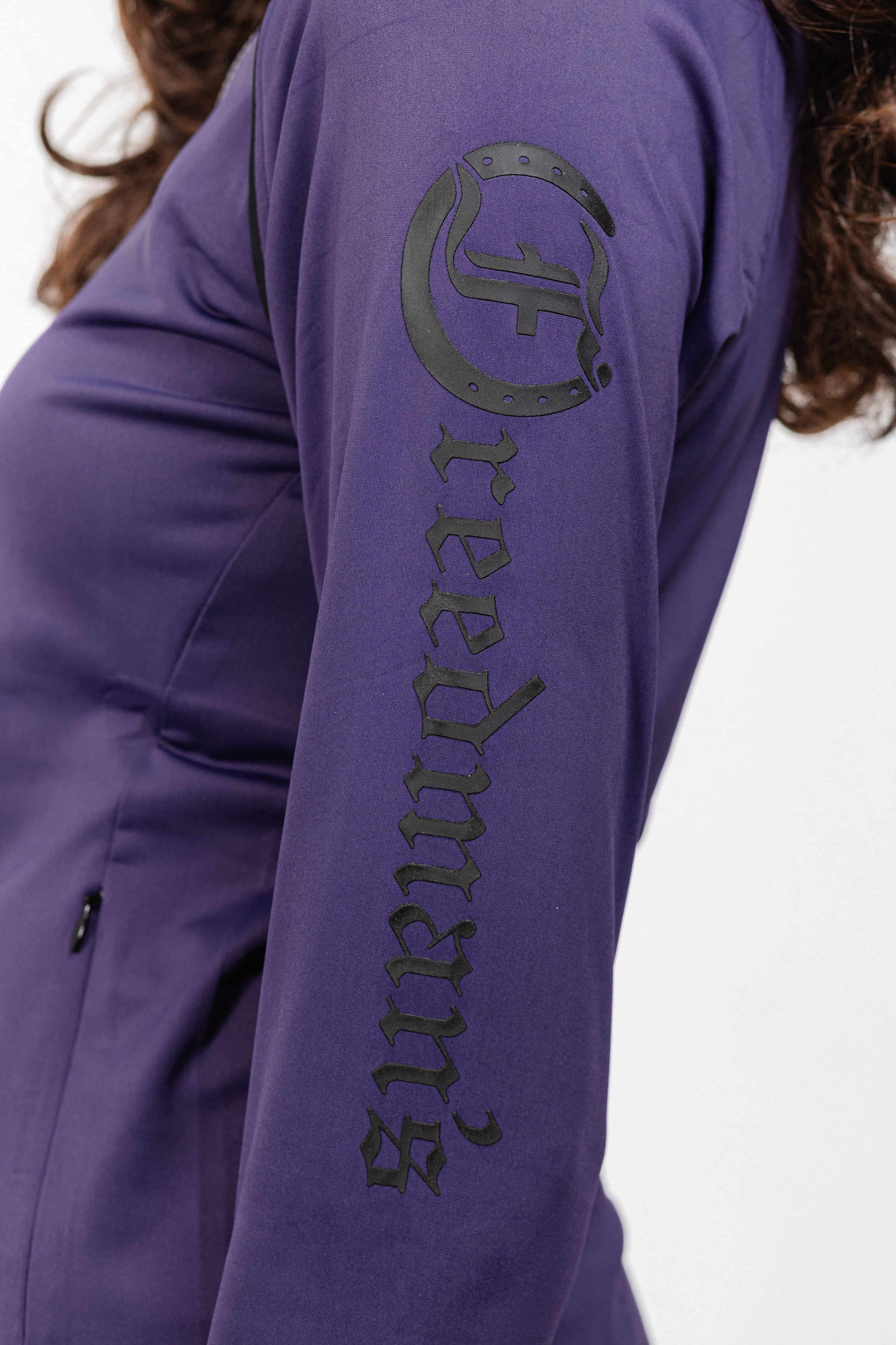 Close-up of Ladies Arum Jacket in purple Showing Freedman's Logo and Arm Detail.