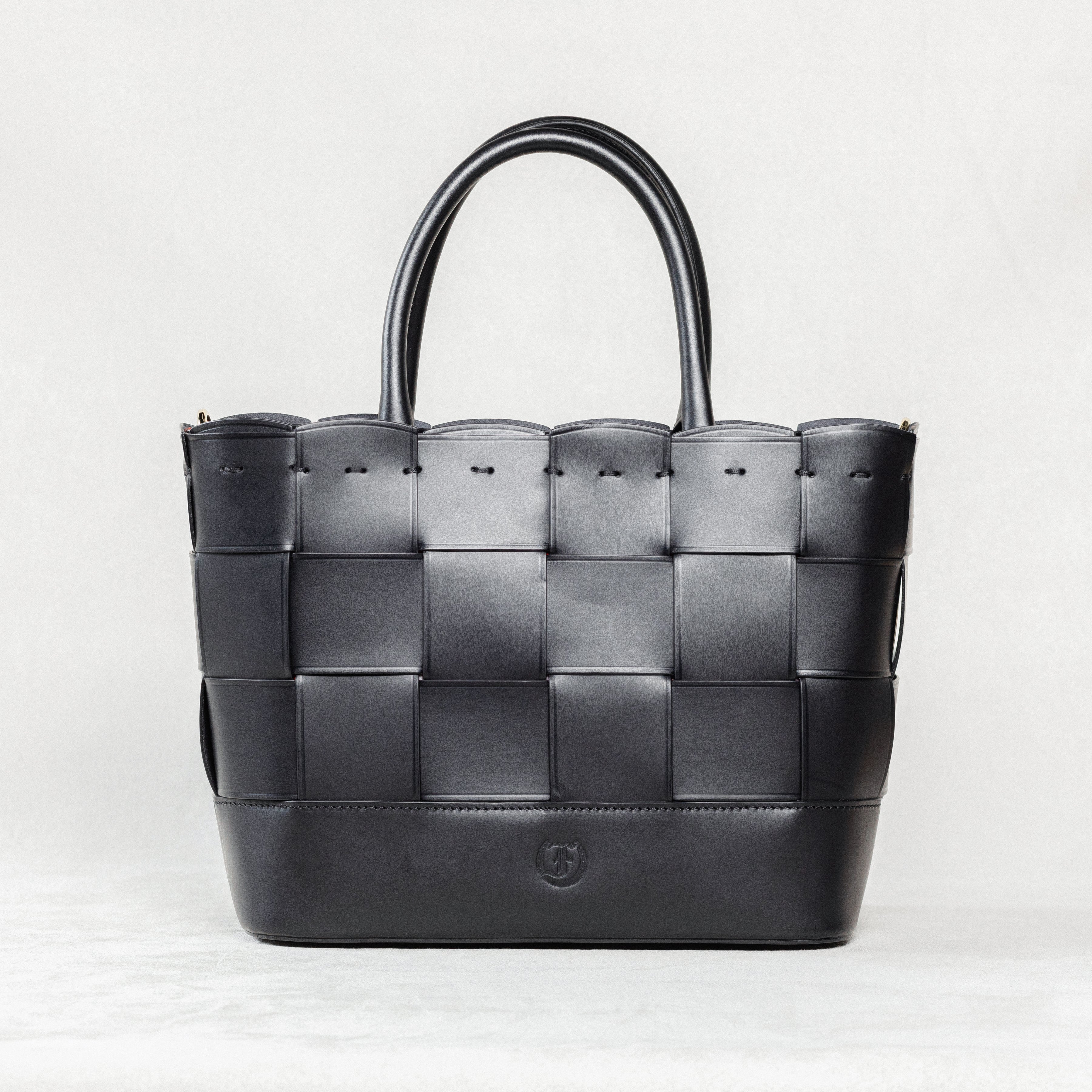 Black Manalos Bag by Freedman's, featuring a woven leather design and structured handles.