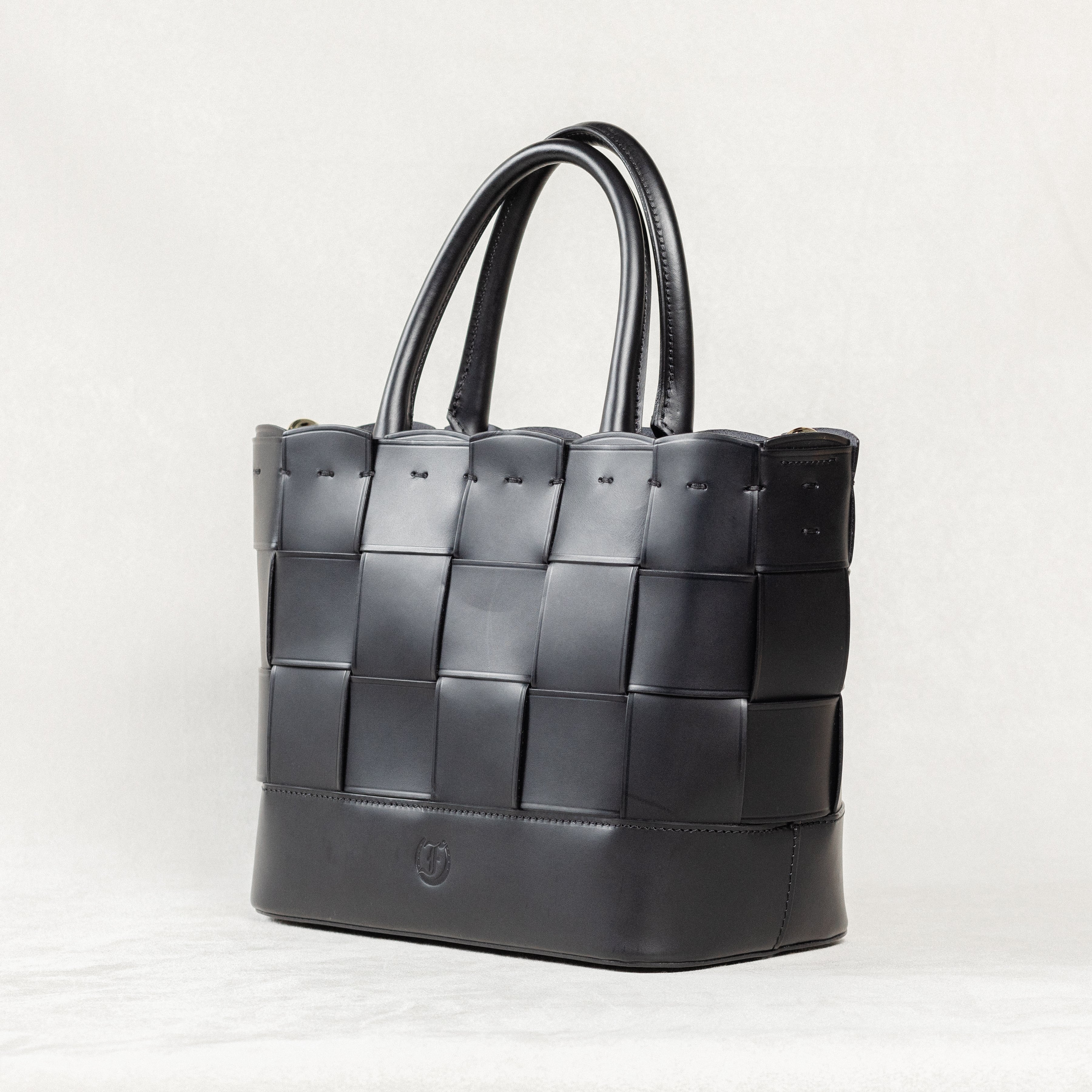 Black Manalos Bag by Freedman's, featuring a woven leather design and structured handles.