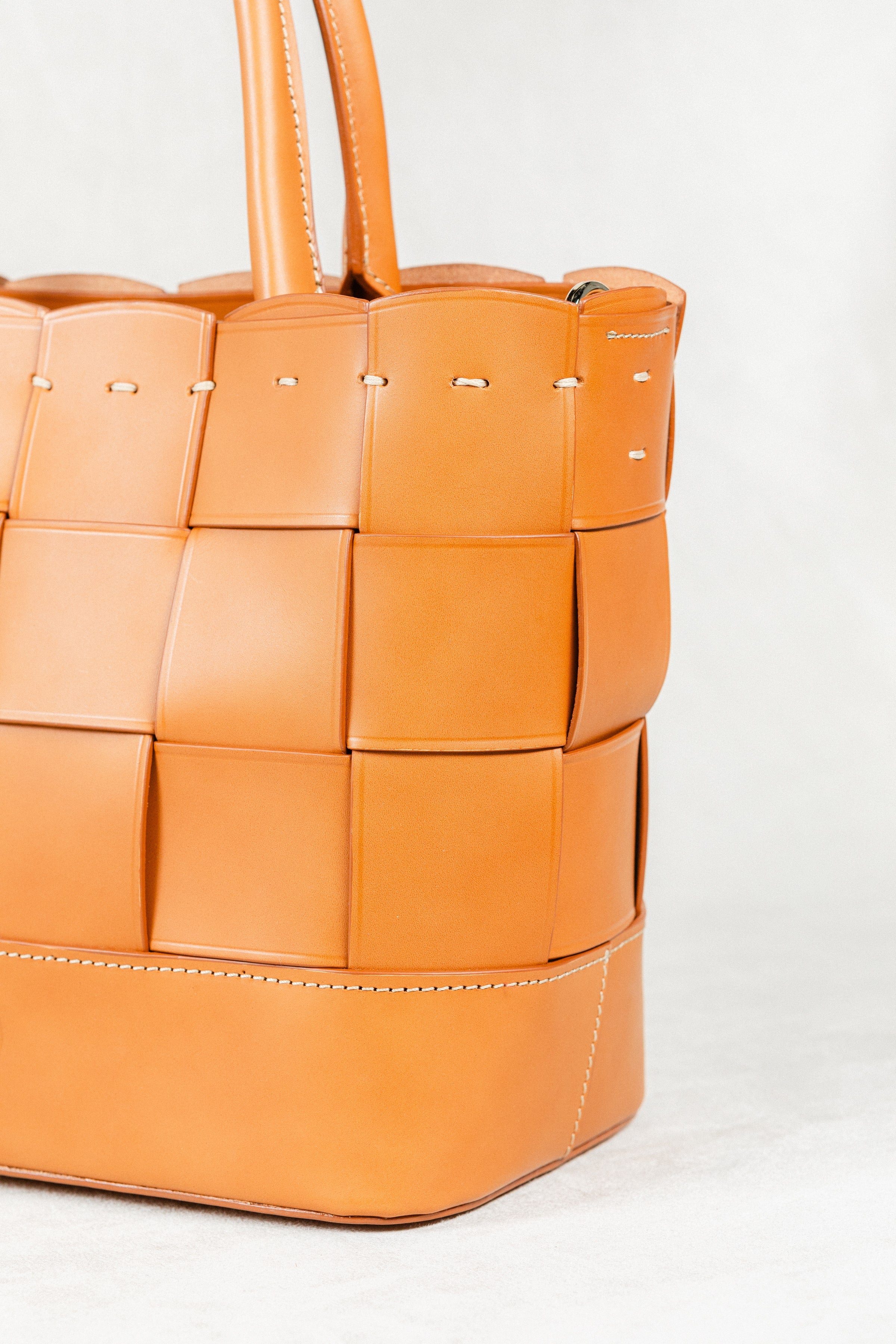 Close-up of cognac Manalos Bag by Freedman's, highlighting the woven leather texture and detailed stitching.