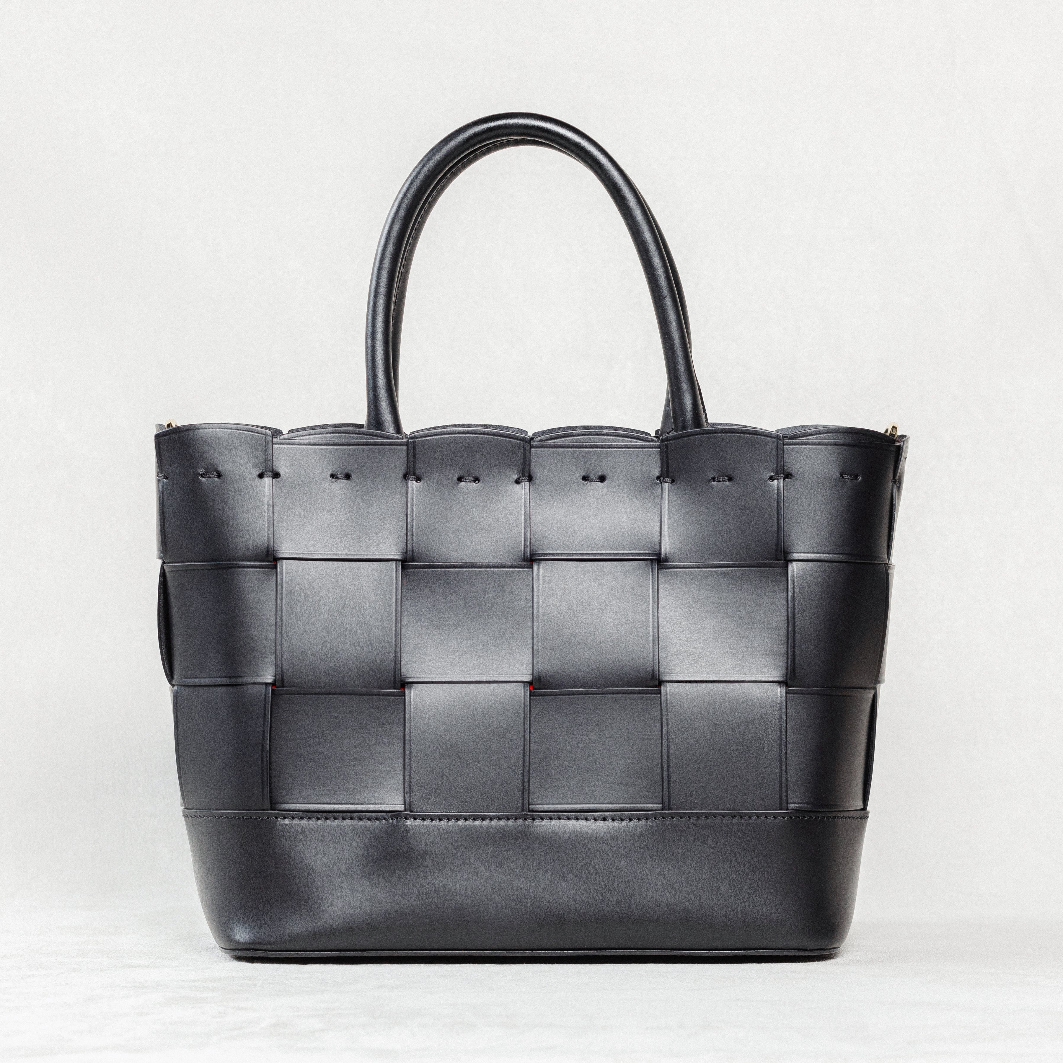 Black Manalos Bag by Freedman's, featuring a woven leather design and structured handles.