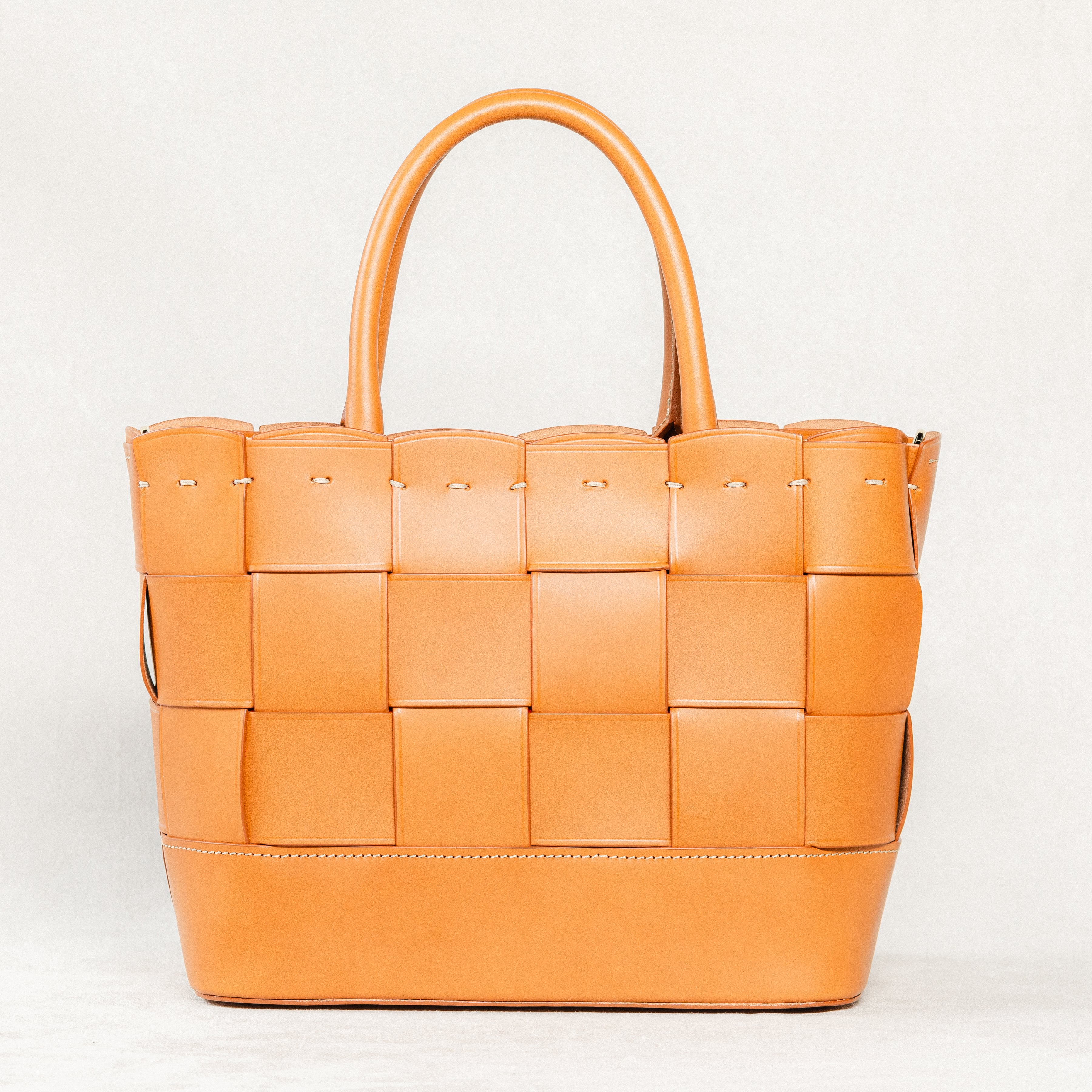 Cognac Manalos Bag by Freedman's, featuring a woven leather design and structured handles.