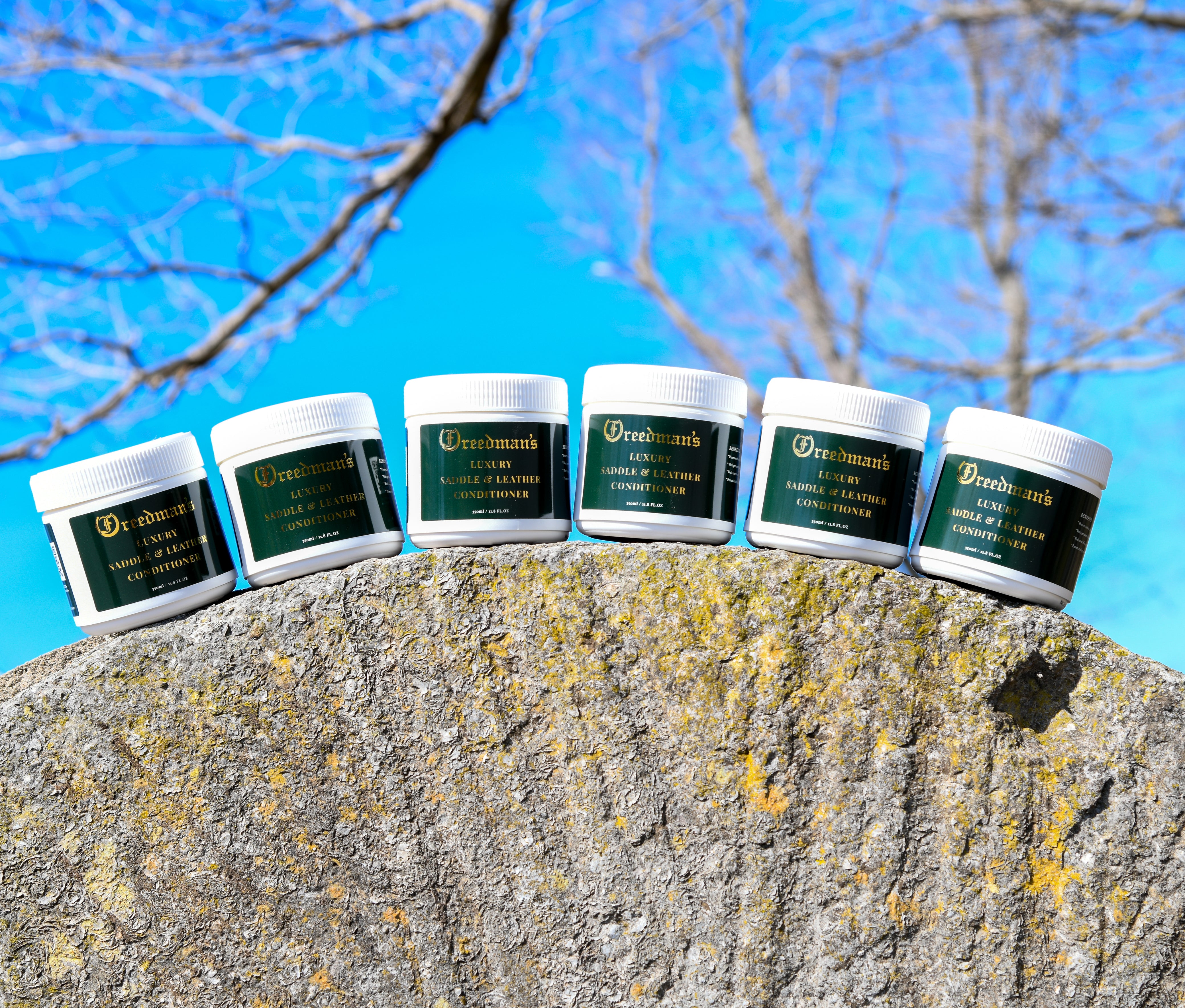 Freedman's Leather Care Products: Six Jars of Luxury Saddle & Leather Conditioner Arranged on a Rock, Outdoor Setting
