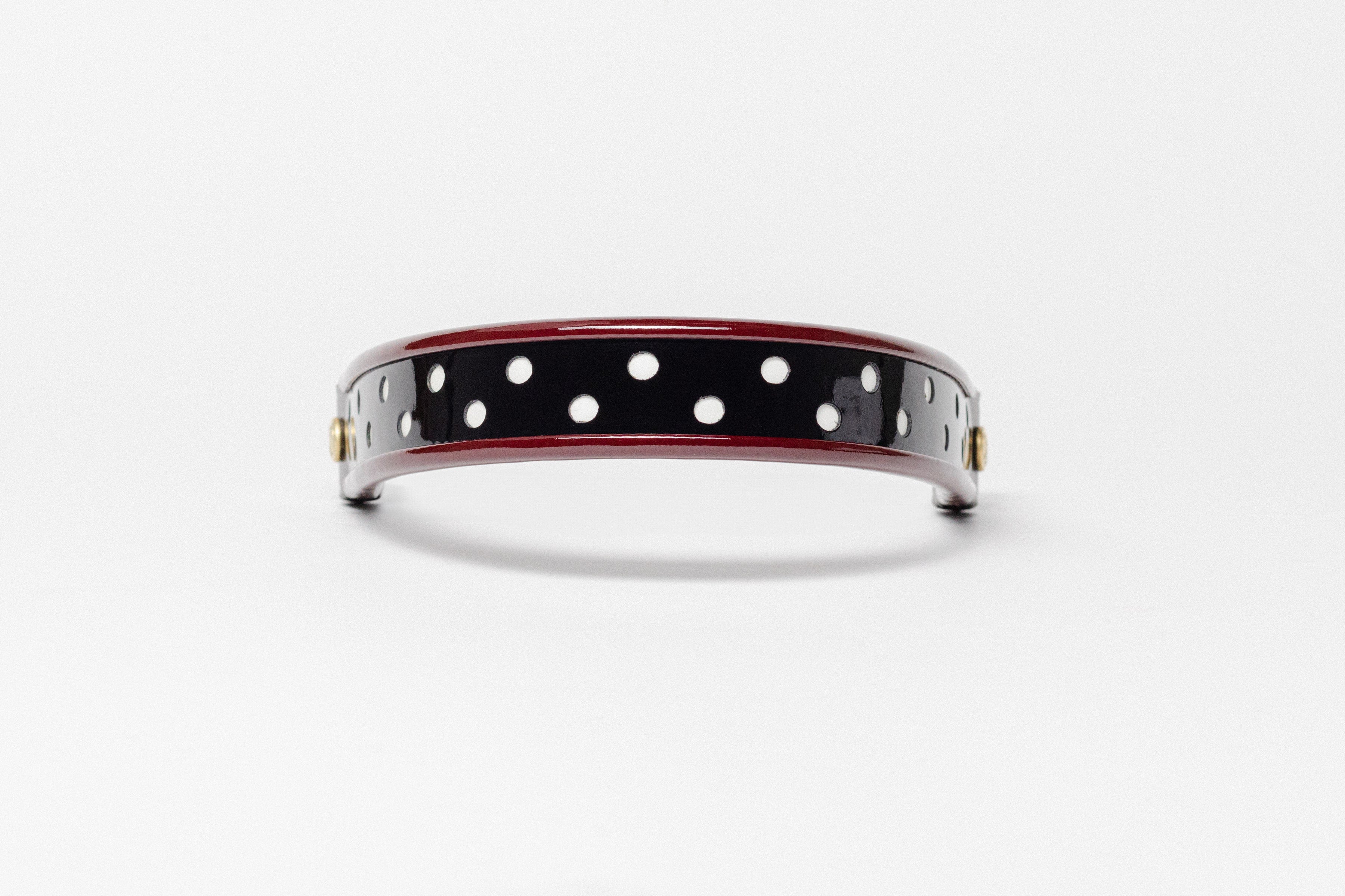 Wide Tapered turned edge browband, black patent leather, red dots, dark brown ends.