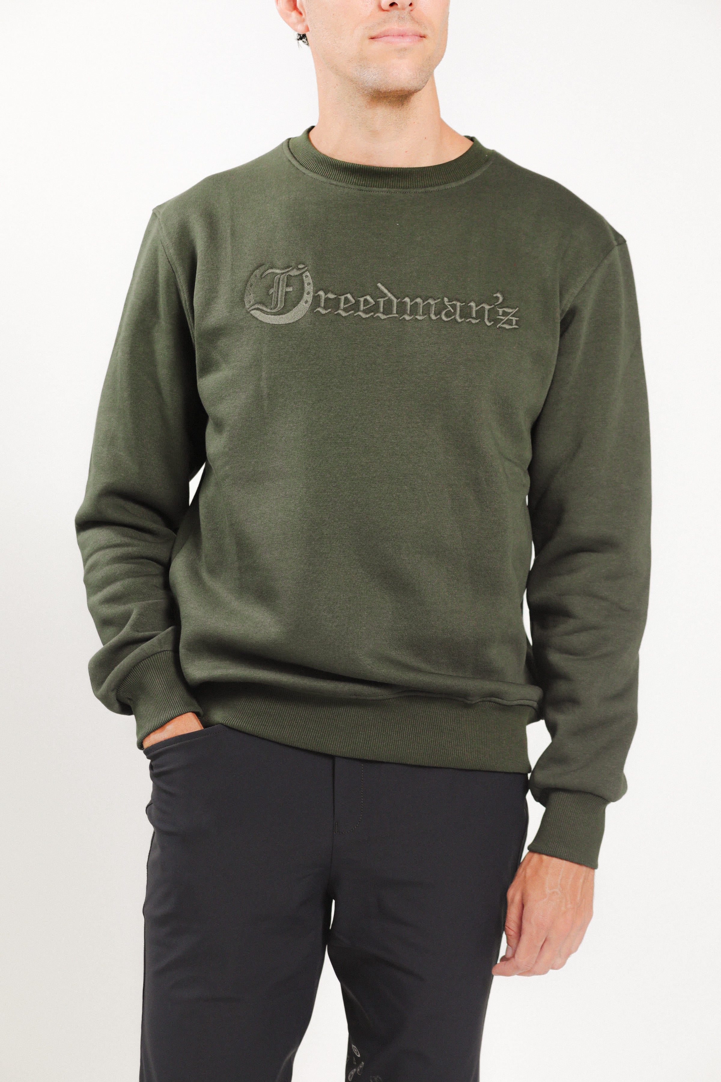 Man wearing Freedman's embroidered crewneck sweatshirts in Green Olive. These stylish and cozy sweatshirts feature a tonal Freedman’s logo, perfect for casual wear and layering
