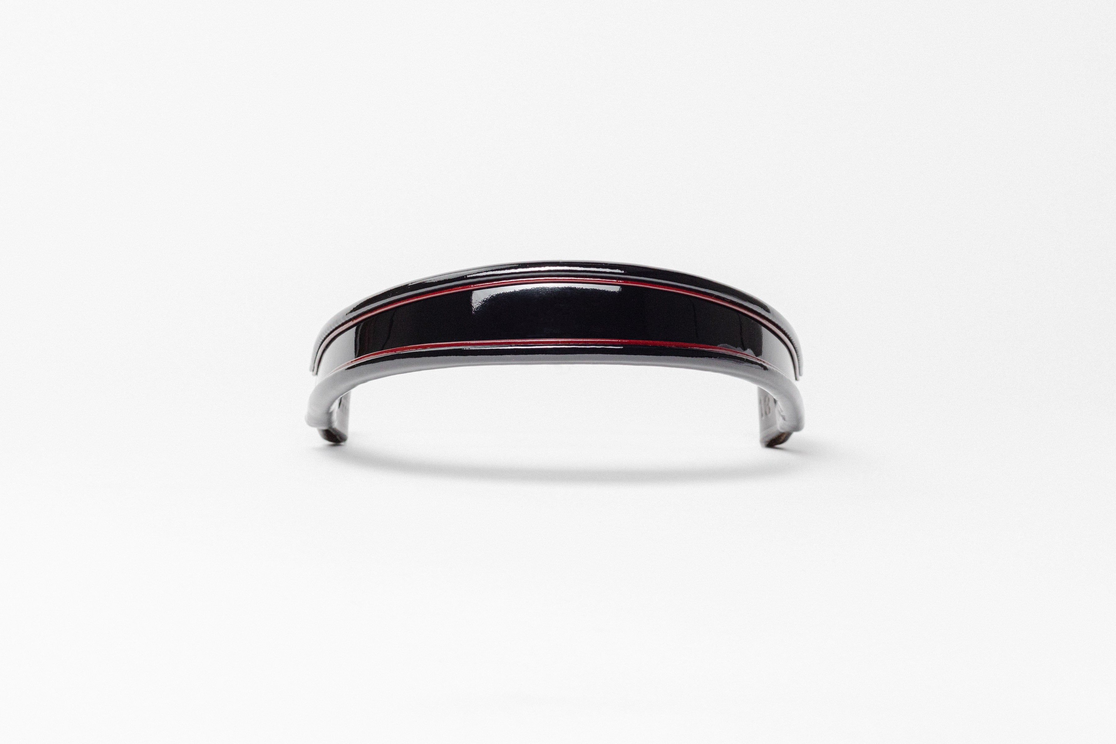 Black and red insert patent leather browband, wide tapered design, turned edge, frontal view showing curved shape.