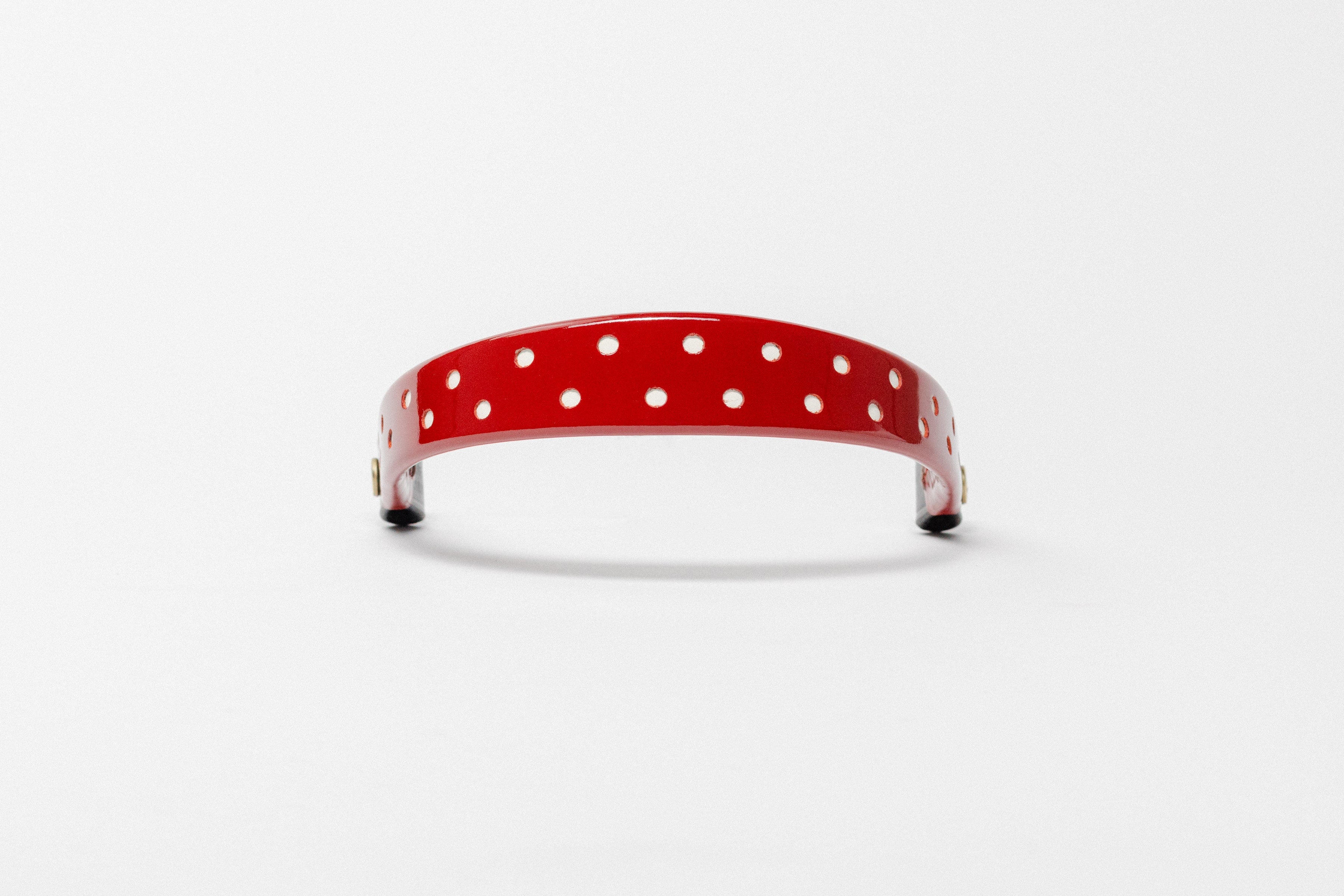 Red Patent Leather Browband with small white dots, wide tapered design, polished brass Freedman logo buttons, and dark leather ends, frontal view.