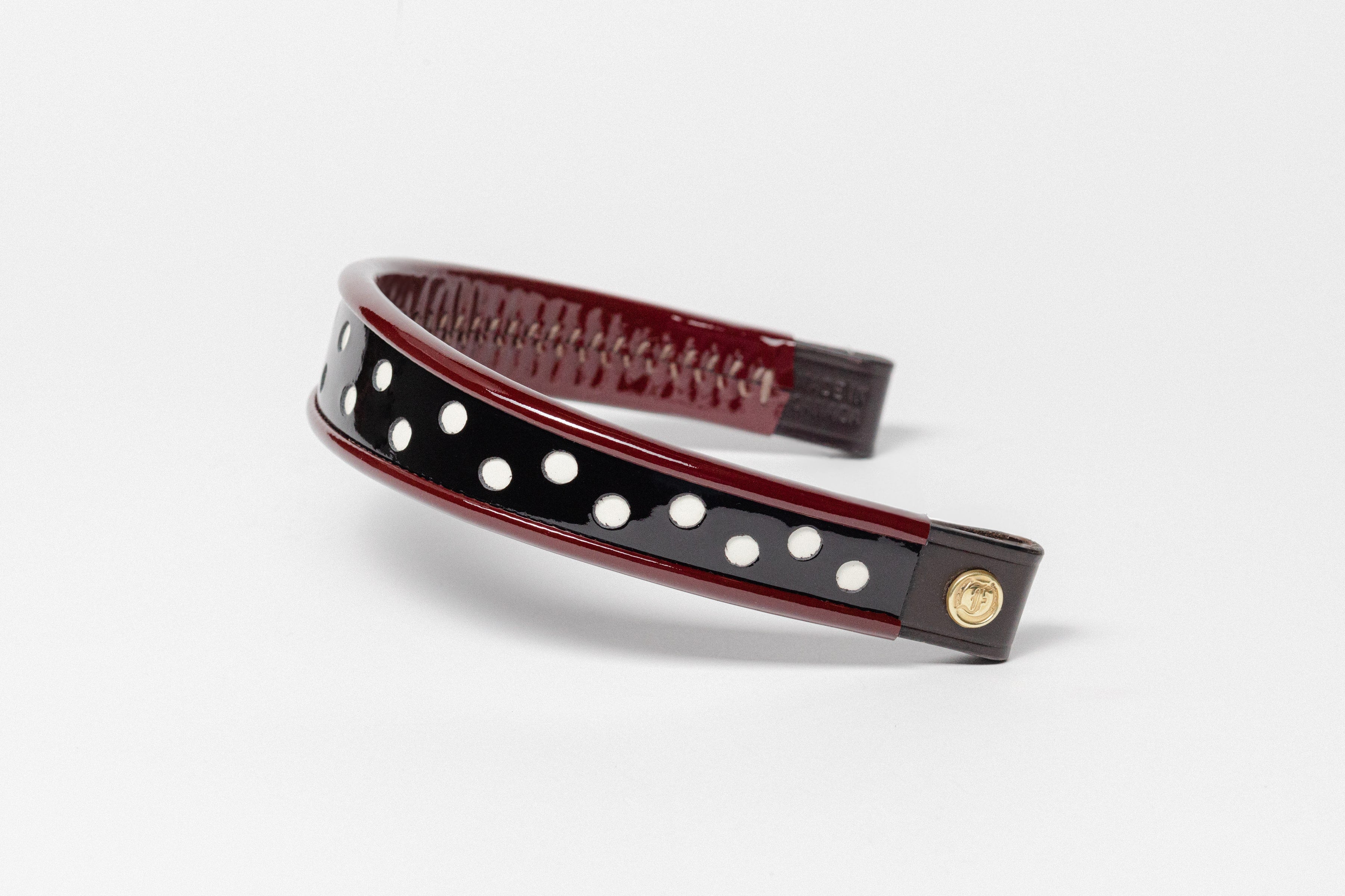 Wide Tapered 13" Turned Edge Browband, Burgundy with white polka dots, glossy finished patent leather, dark leather ends with gold button detail, shown on white background.