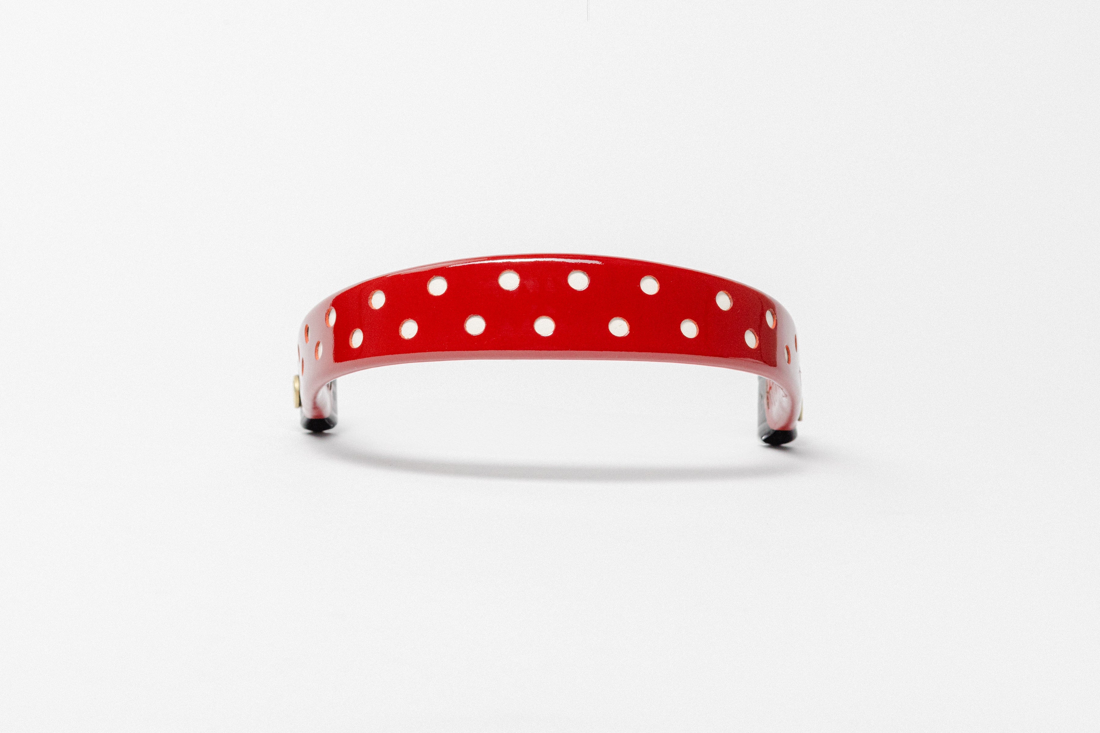 Wide Tapered Patent Leather Browband red with small white dots and polished brass Freedman logo buttons, frontal view.