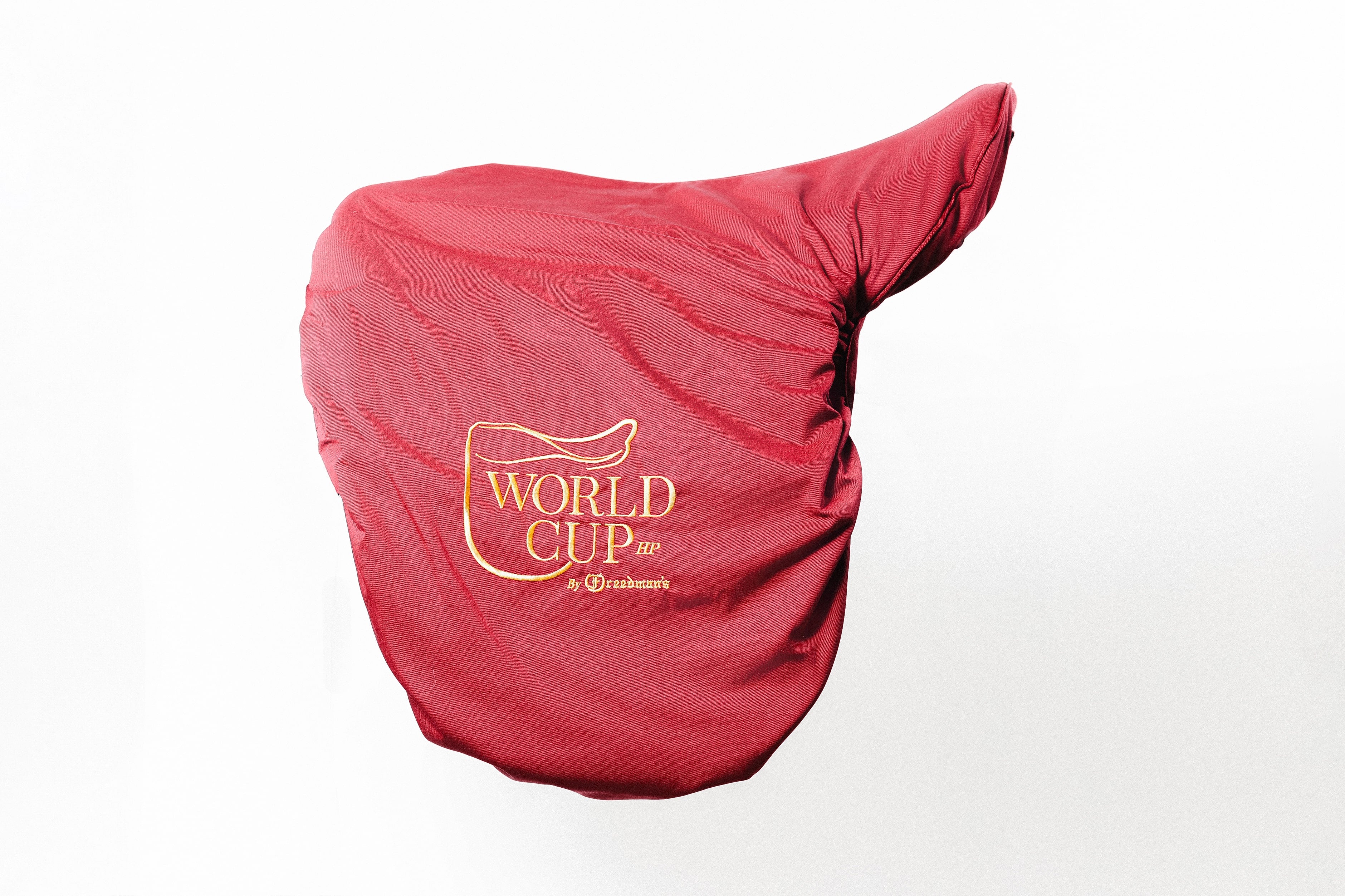 Red saddle cover designed for Freedman's World Cup HP Saddle. Features a white embroidered World Cup logo by Freedman's.