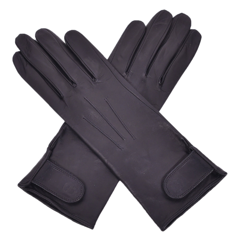 The Yorkville Show Glove, black leather gloves crossed, with wrist strap and button detail, visible seam stitching, light background.