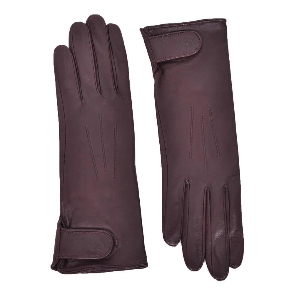 The Yorkville Show Glove, dark brown leather gloves shown separately, each with wrist strap and button detail, visible seam stitching, light background.