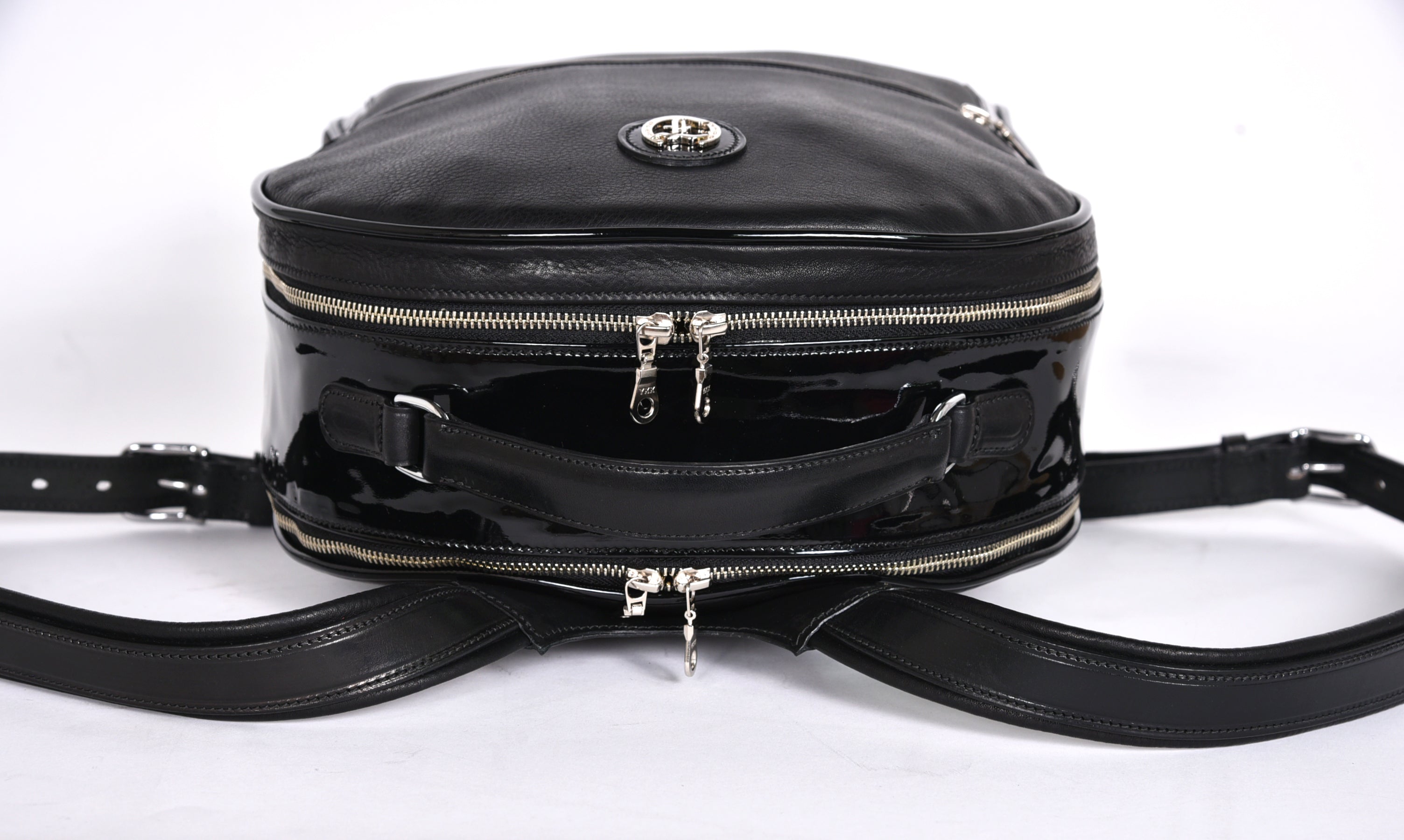 Black leather backpack, The Jaunty by Freedman's, rear view with dual zippers, patent leather accent, and adjustable shoulder straps.