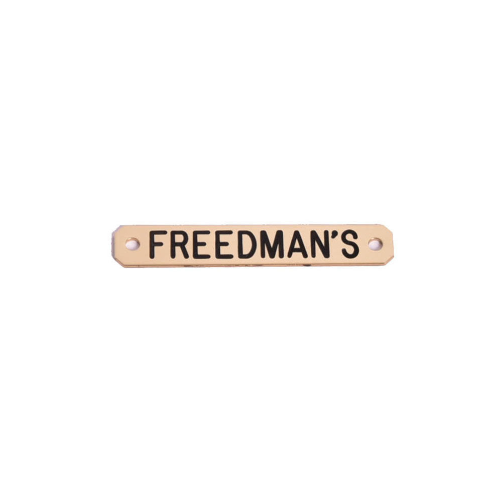 Freedman's Saddle Name Plate in brass with black lettering, displayed on a white background.