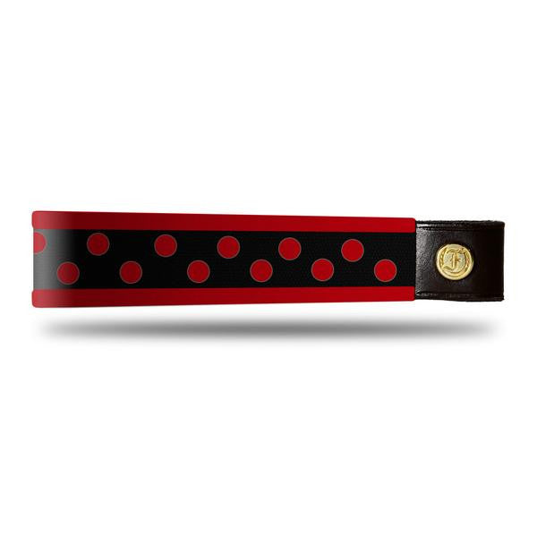 Red and Red dot patent leather browband, wide tapered design, turned edge, dark leather ends with gold button, shown flat.