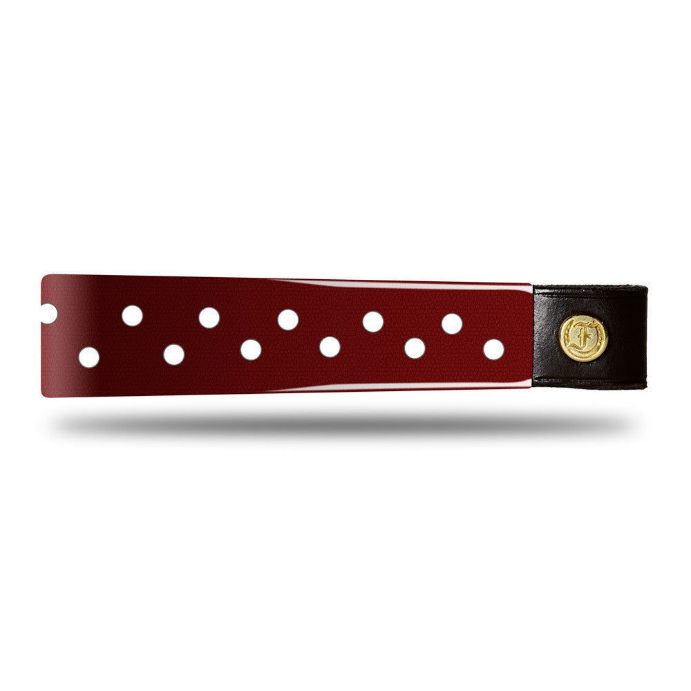 Burgundy Patent Leather Browband with small white dots, wide tapered design, polished brass Freedman logo buttons, and dark leather ends, laid flat.