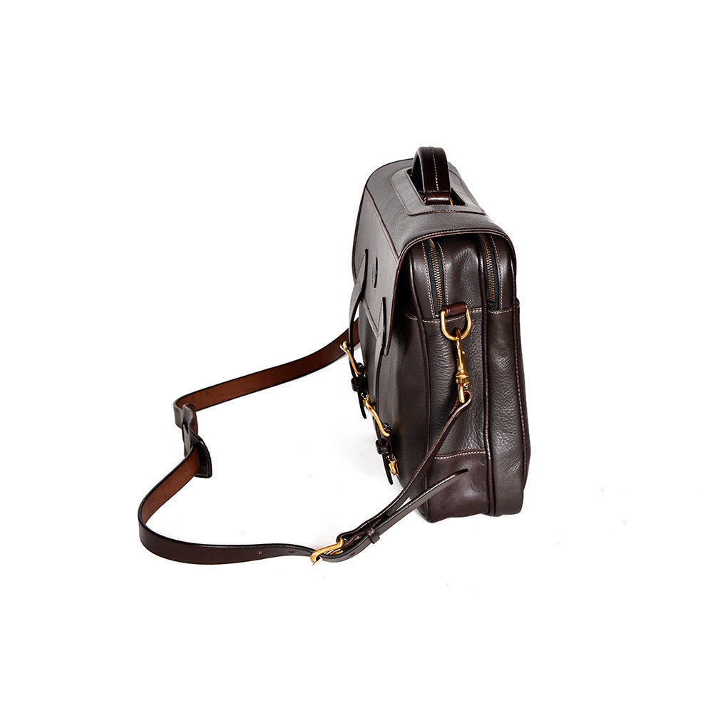 Dark Brown leather briefcase, Wagonette model, angled profile with zipper closure, shoulder strap, and handle detail.