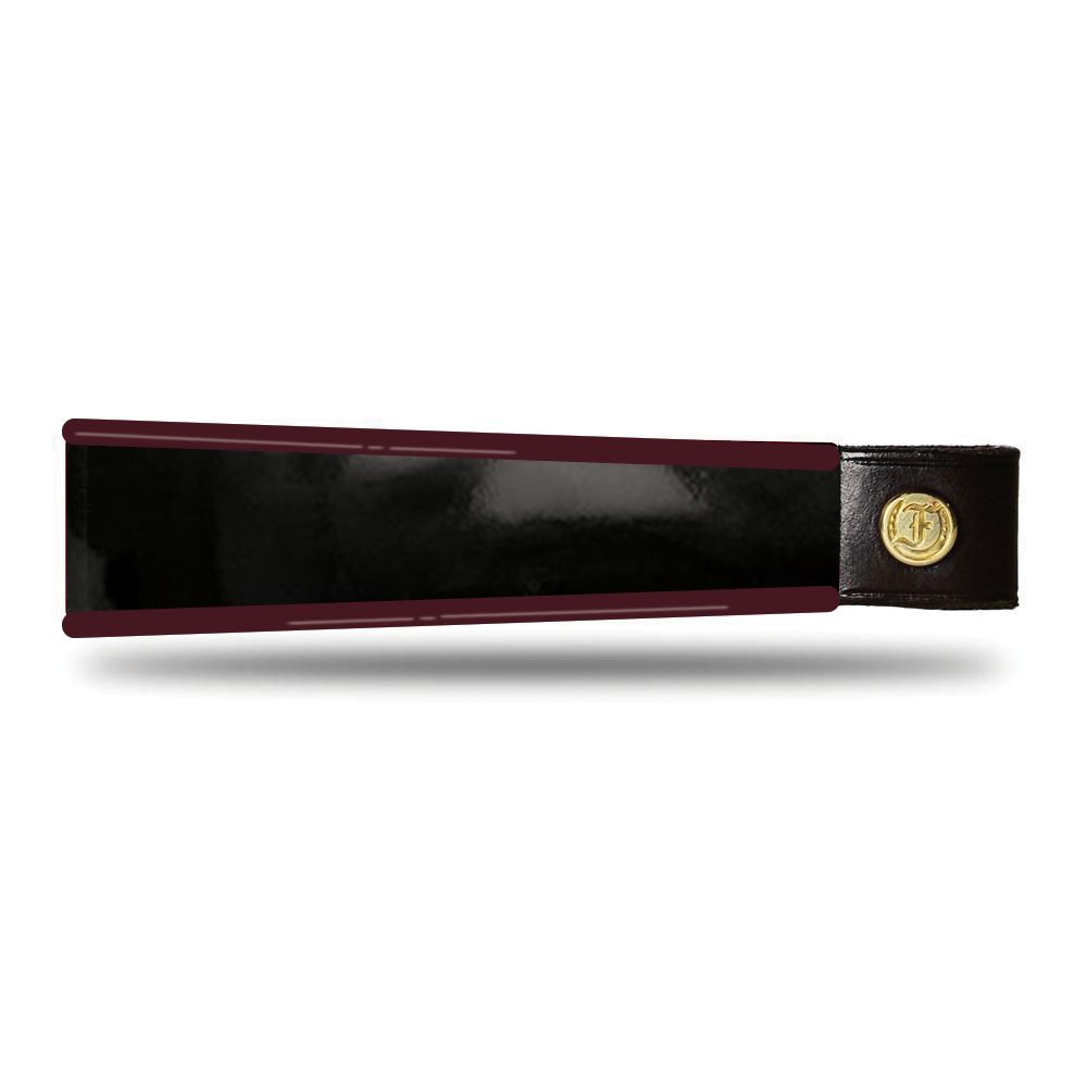 Burgundy and black patent leather browband, wide tapered design, turned edge, polished brass Freedman logo buttons, laid flat.